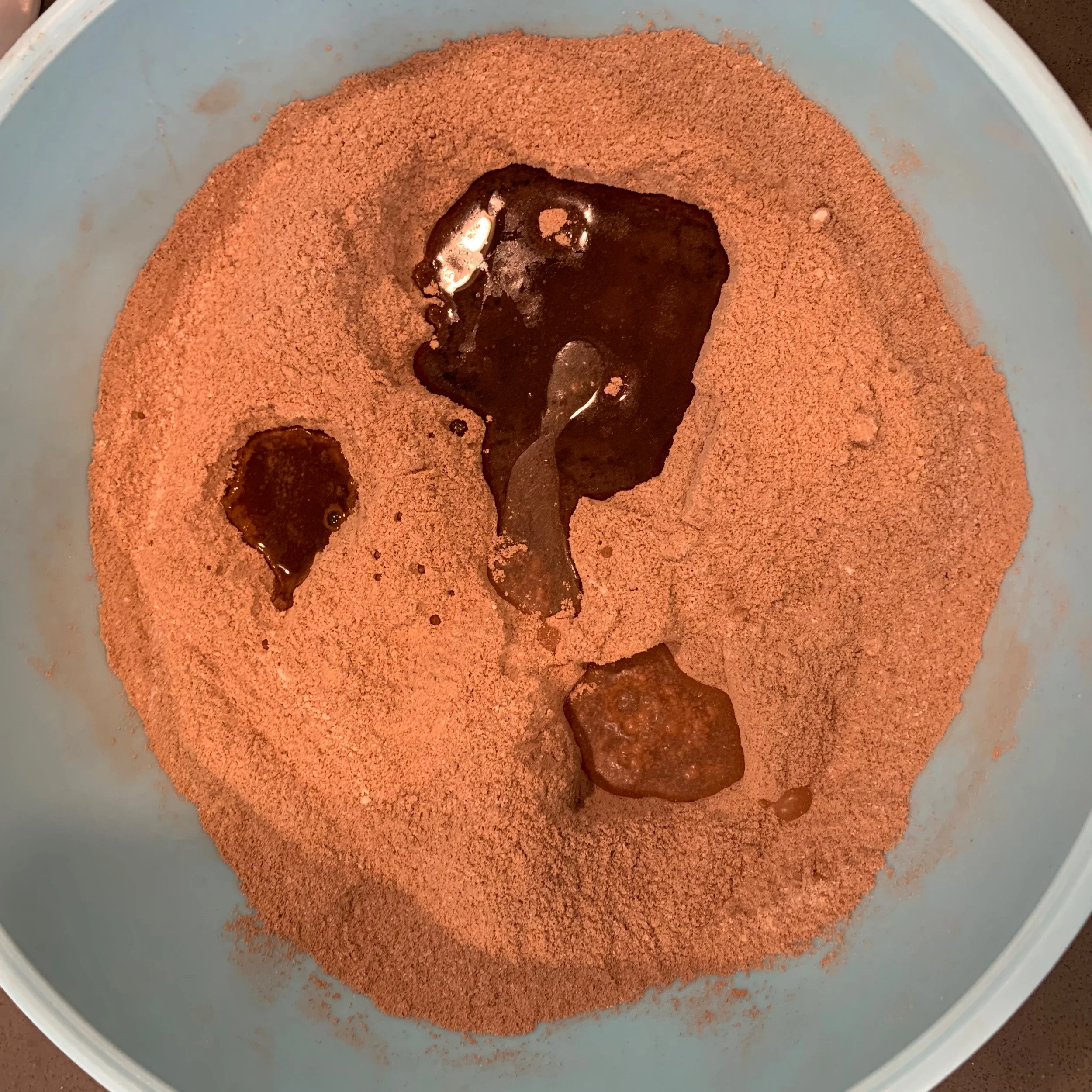 Pour the wet ingredients separately into the holes.