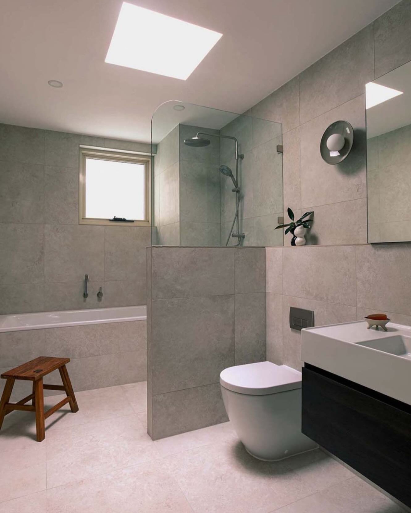 Looking back to this master ensuite bathroom. 
Large format tile on the floors + walls = a true sense of calm