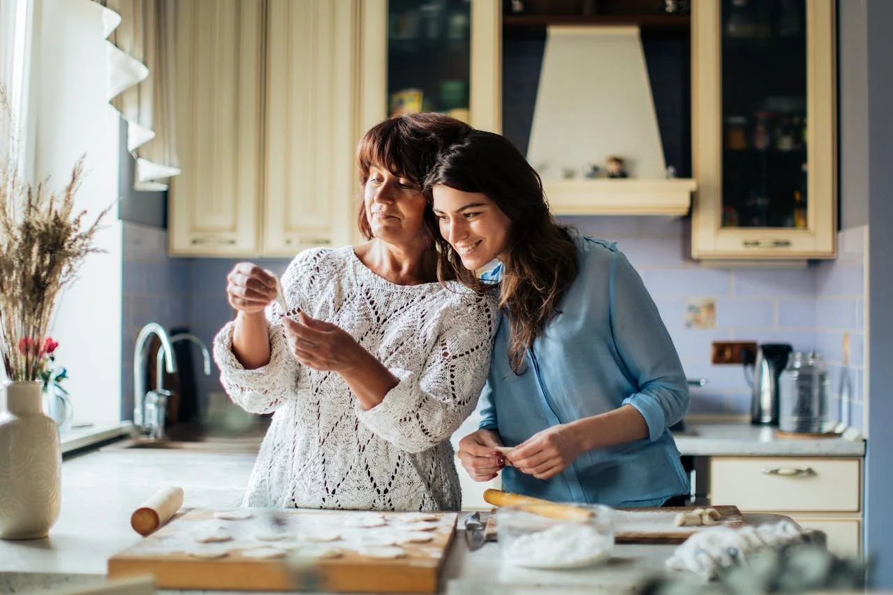 two women baking together in kitchen