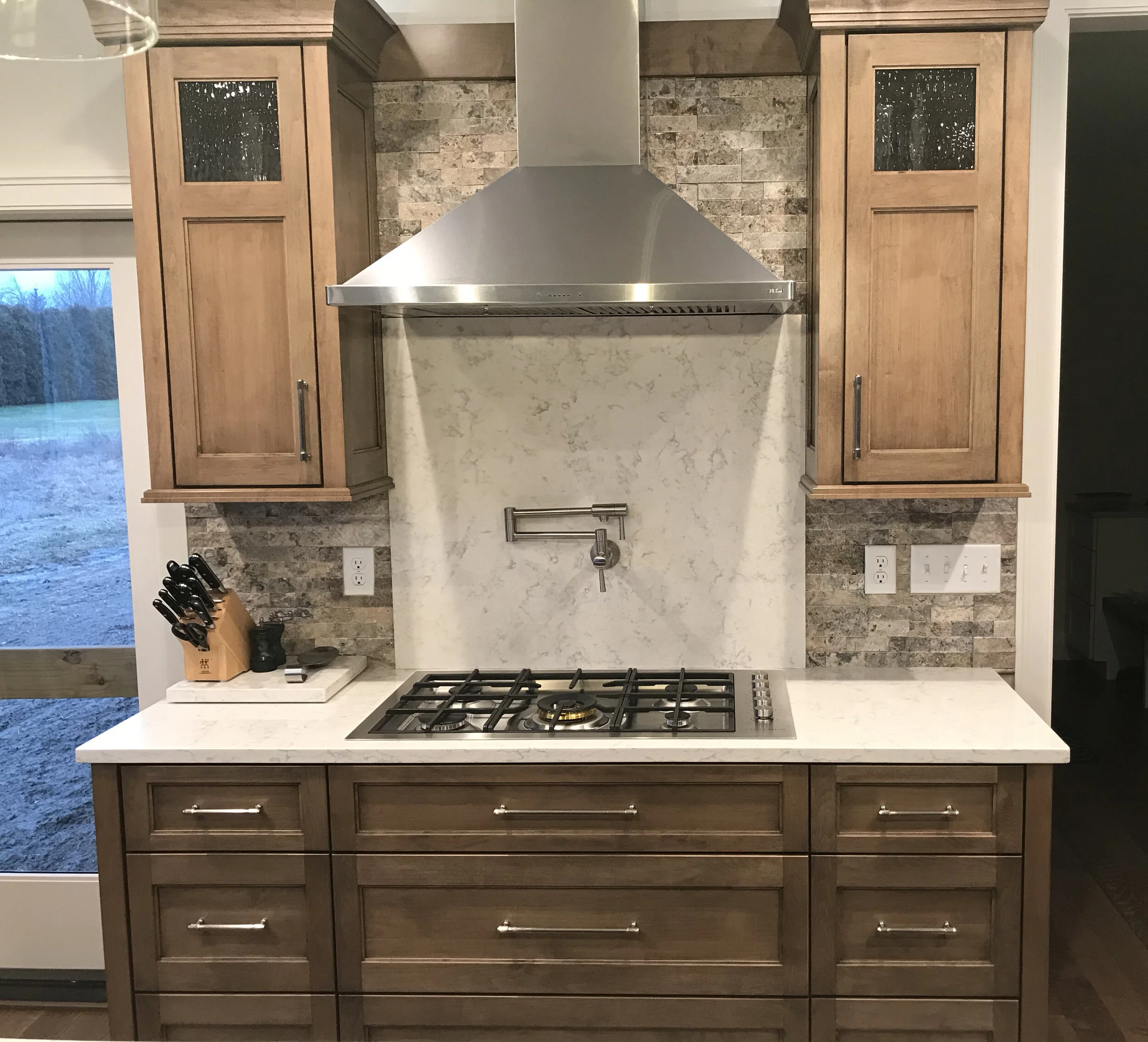 Custom wood kitchen cabinets with natural finish.