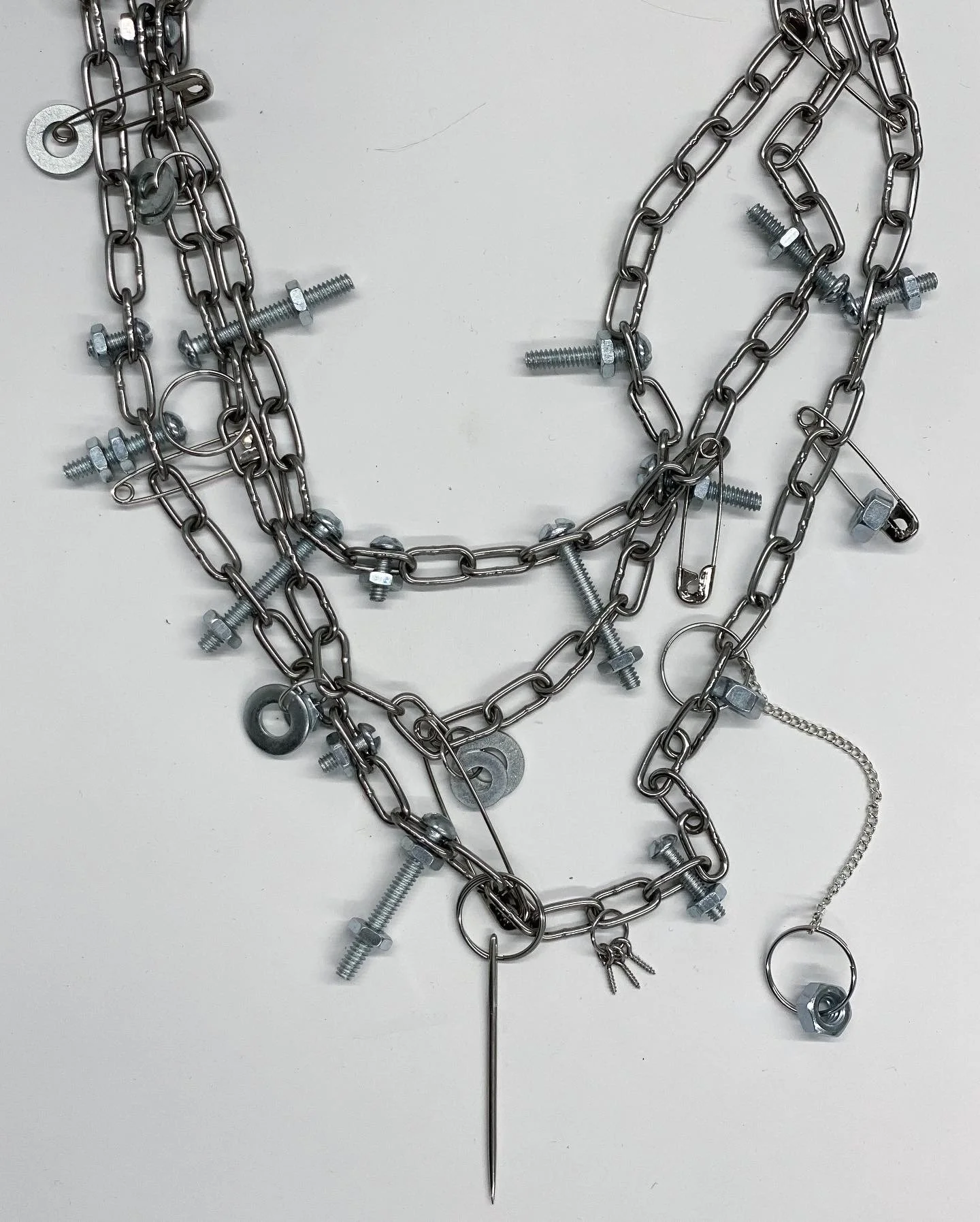  Chain necklace embedded with washers, nuts, bolts, other stuff. 