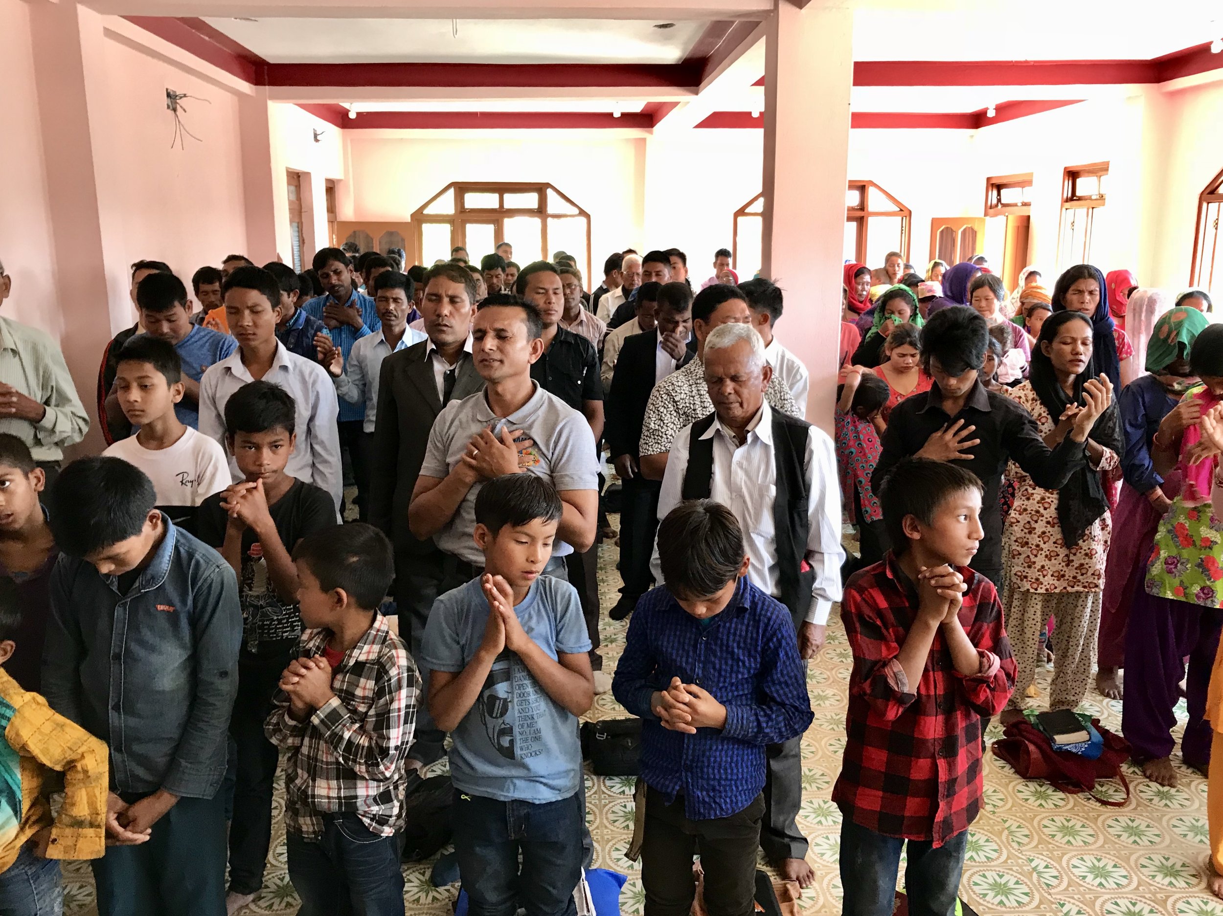 Nepalese believers praying passionately at the weekend service.jpg