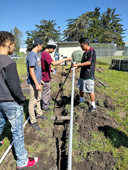 Students prime and glue pipe