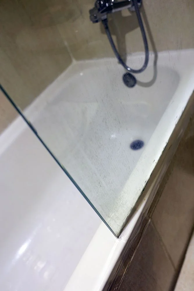 Our shower had no curtain, just a grimy piece of glass that covered half of the tub area.