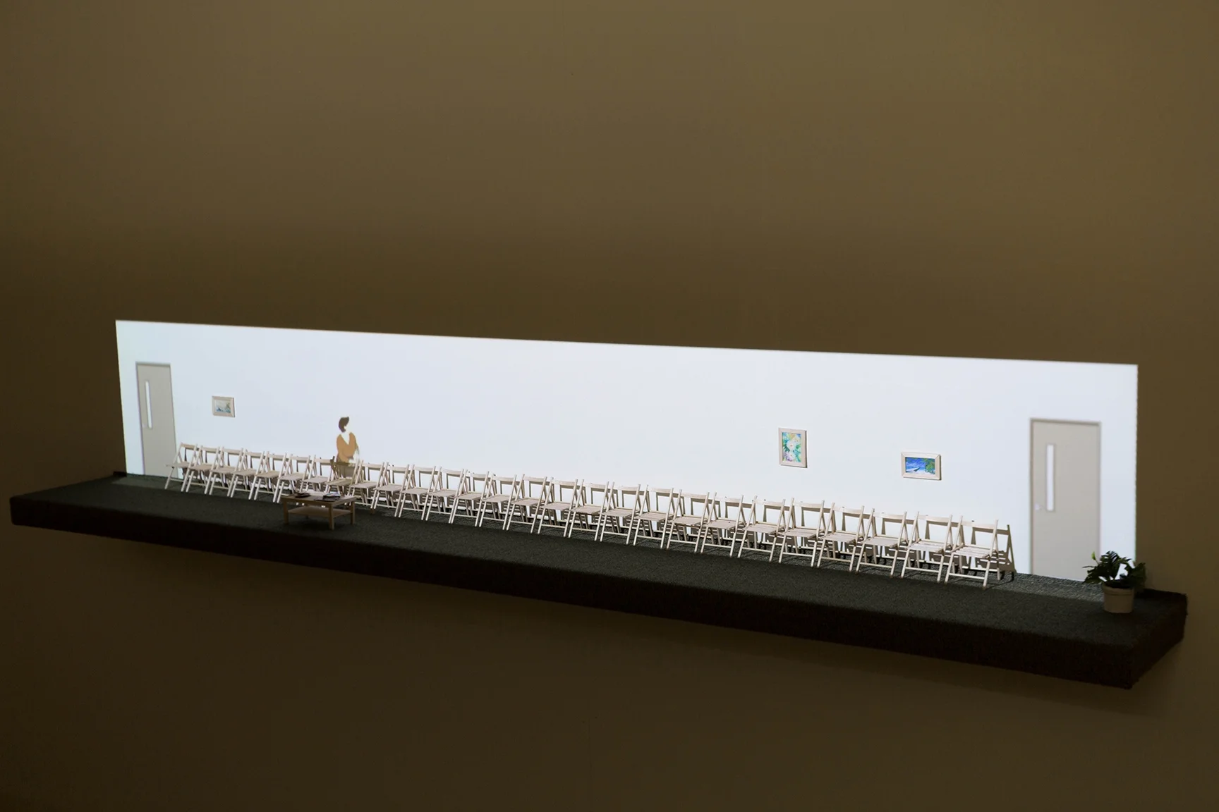  Good Girl is a multi-media sculpture composed of a single-channel animation projected over a miniature waiting room. The completed piece runs on a 14-minute seamless loop.  Single-channel animation, balsa wood, fabric, clay, potting soil, plywood, p