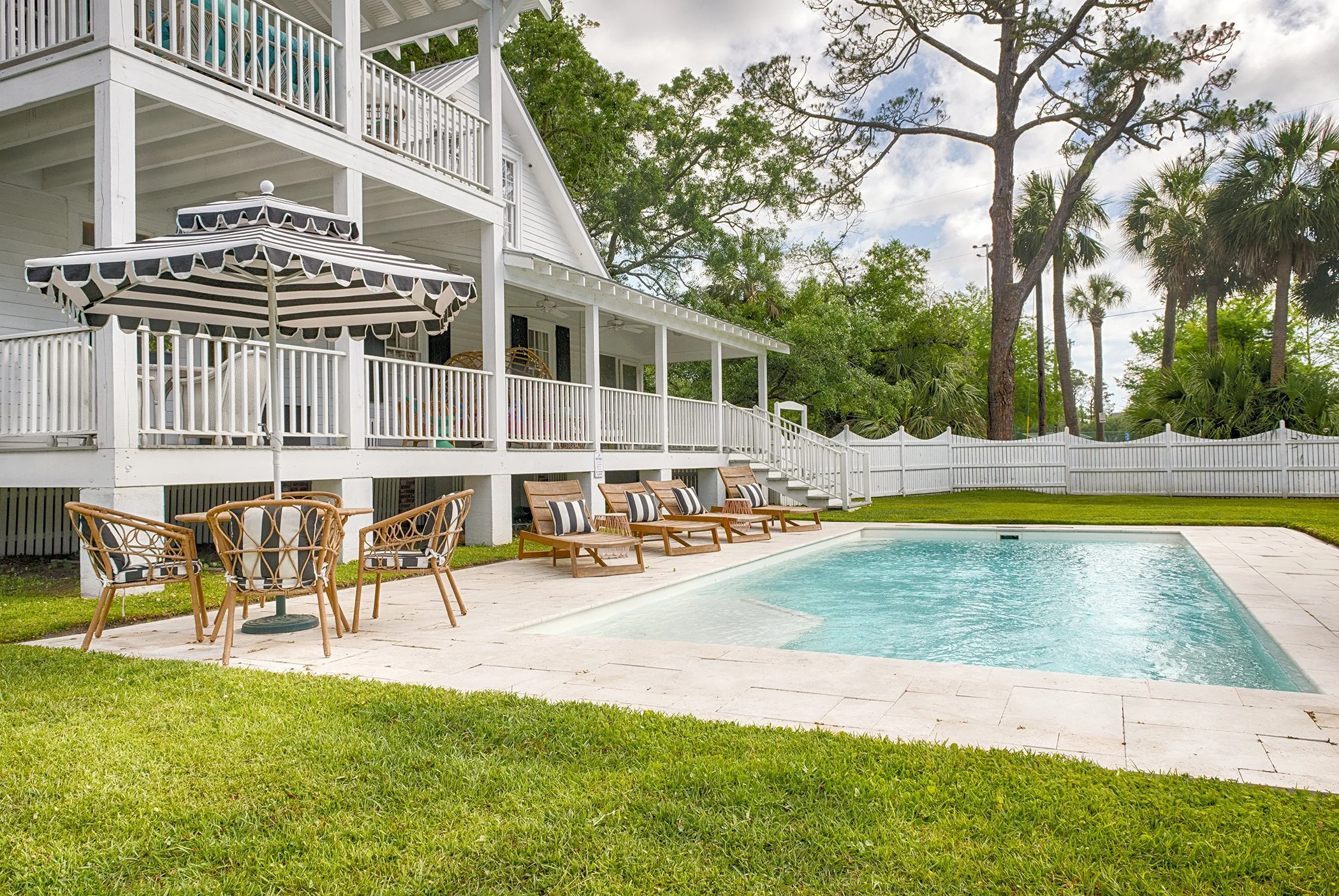 Outdoor view of the pool, patio, and porches at Bliss Cottage on Tybee Island.