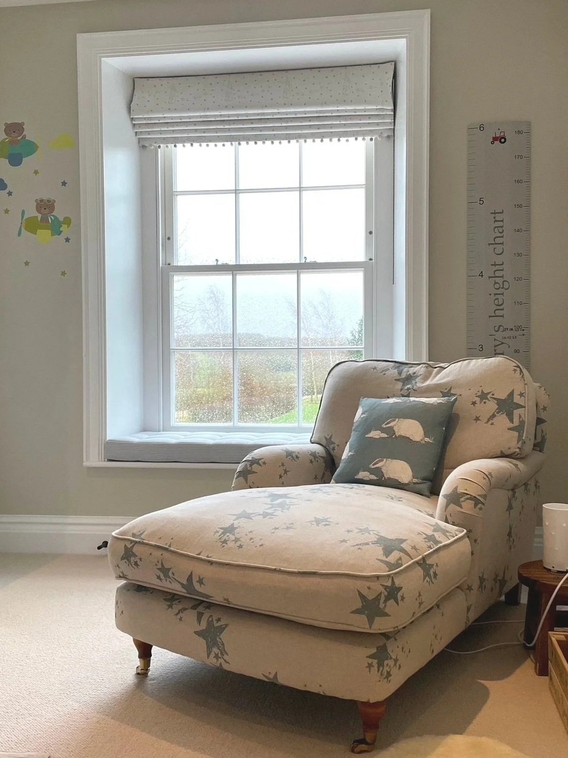 Wonderful fabrics in a little boy's nursery. Roman blind, window seat and recovered big squidgy chair.  