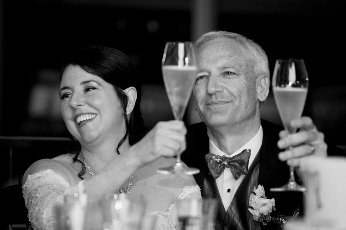 Newseum wedding couple toasting Washington DC - Planning by Bella Notte and Photo by Deb Lindsey Photography
