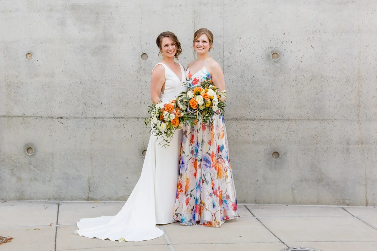 Modern bride and bridesmaid in a floral dress, DC wedding at Arena Stage, Planning by Bella Notte, Photo by Procopio Photography