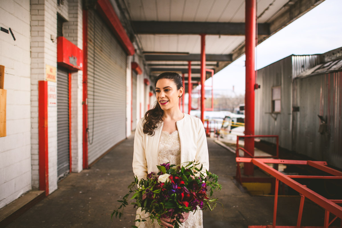 Modern bride with a red and purple wedding bouquet at Dock 5 at Union Market, DC, Planning by Bella Notte, Photo by Sam Hurd