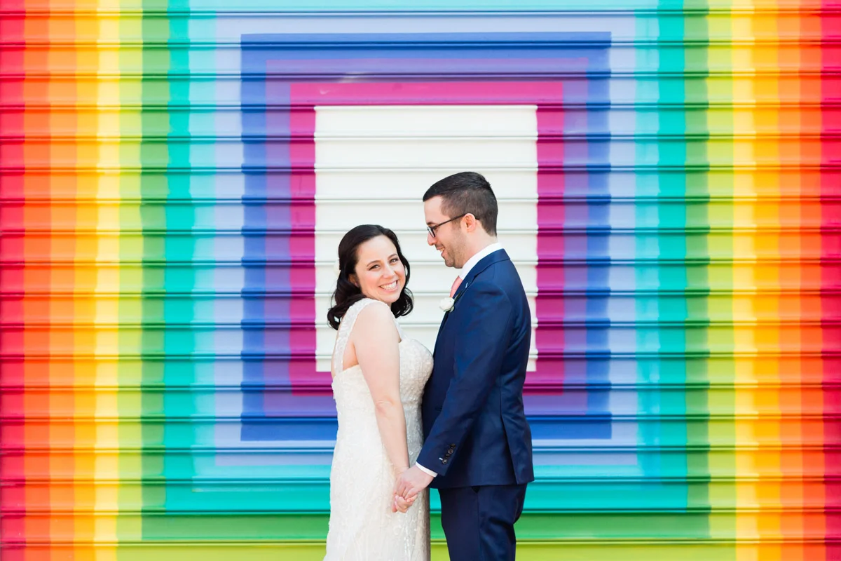 Bride and groom in front of geometric rainbow mural at Longview Gallery DC wedding, Planning by Bella Notte and Photo by Lisa Boggs Photography