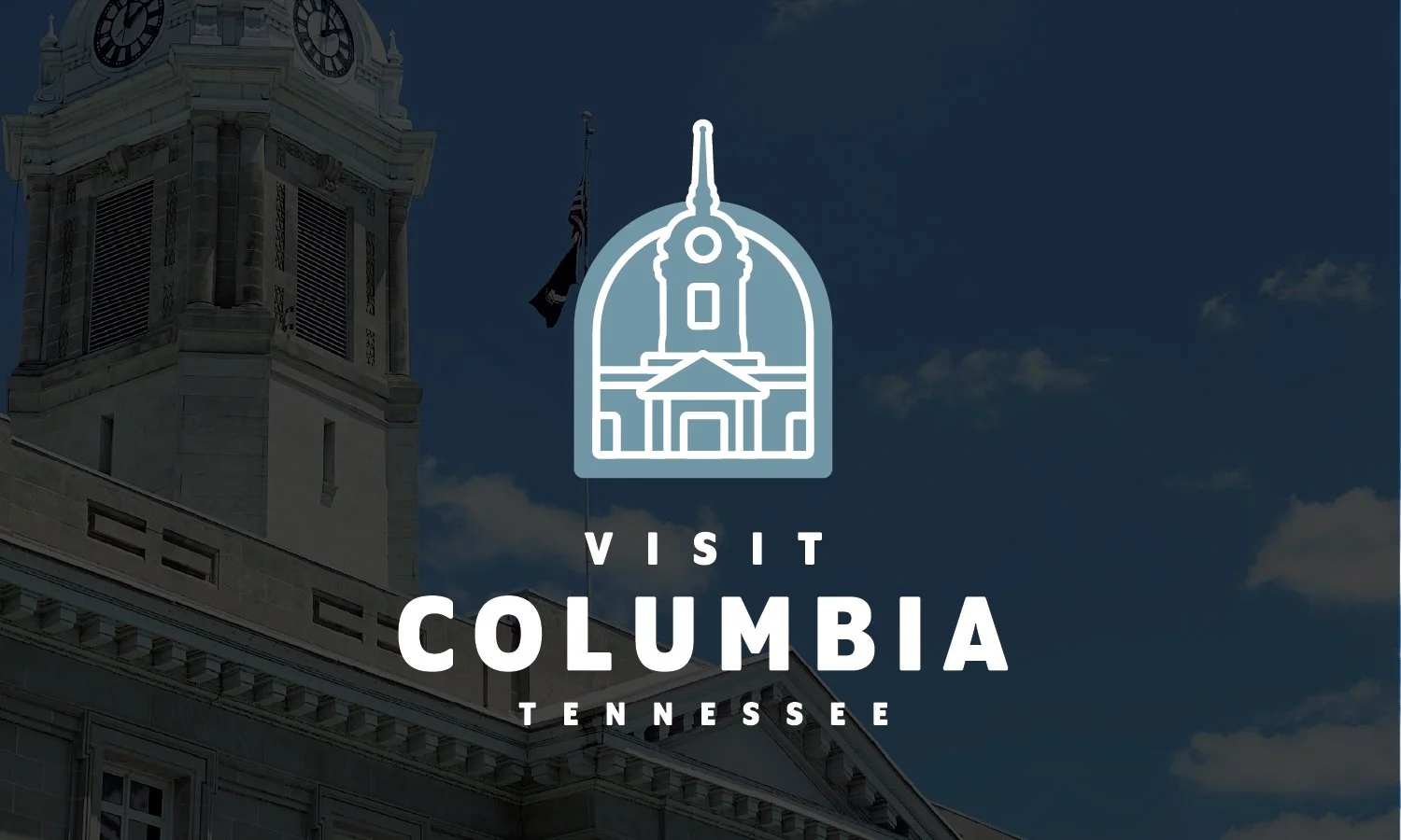 Promotional image for visiting Columbia, Tennessee, featuring a stylized outline of a historic building or clock tower and the text 'Visit Columbia Tennessee' over a blue sky with clouds.