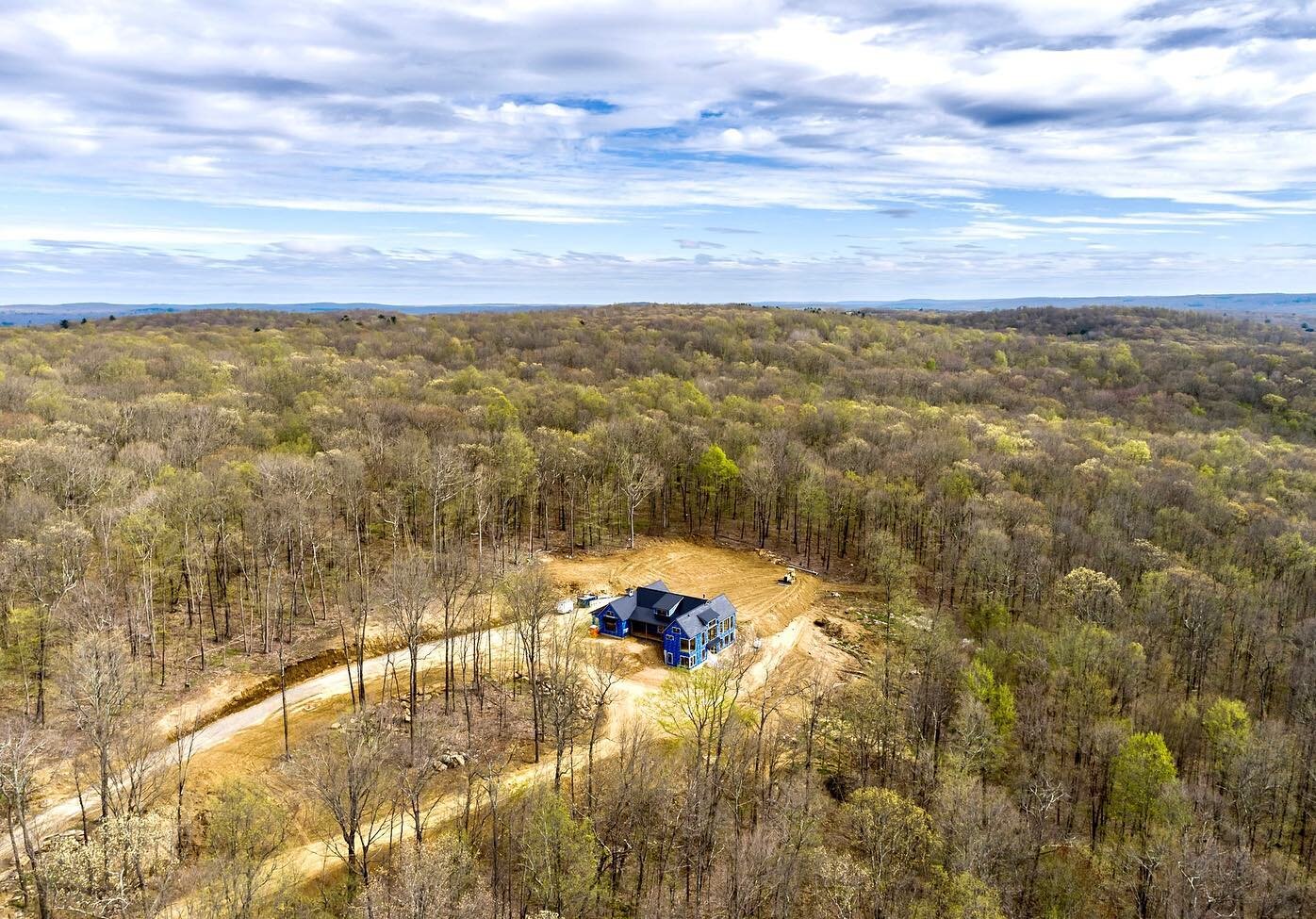 A few shots of our modern #netzero project with no other house in site.  Drone photography by our friends @aerialscope. #netzero #teslasolarroof #teslasolar