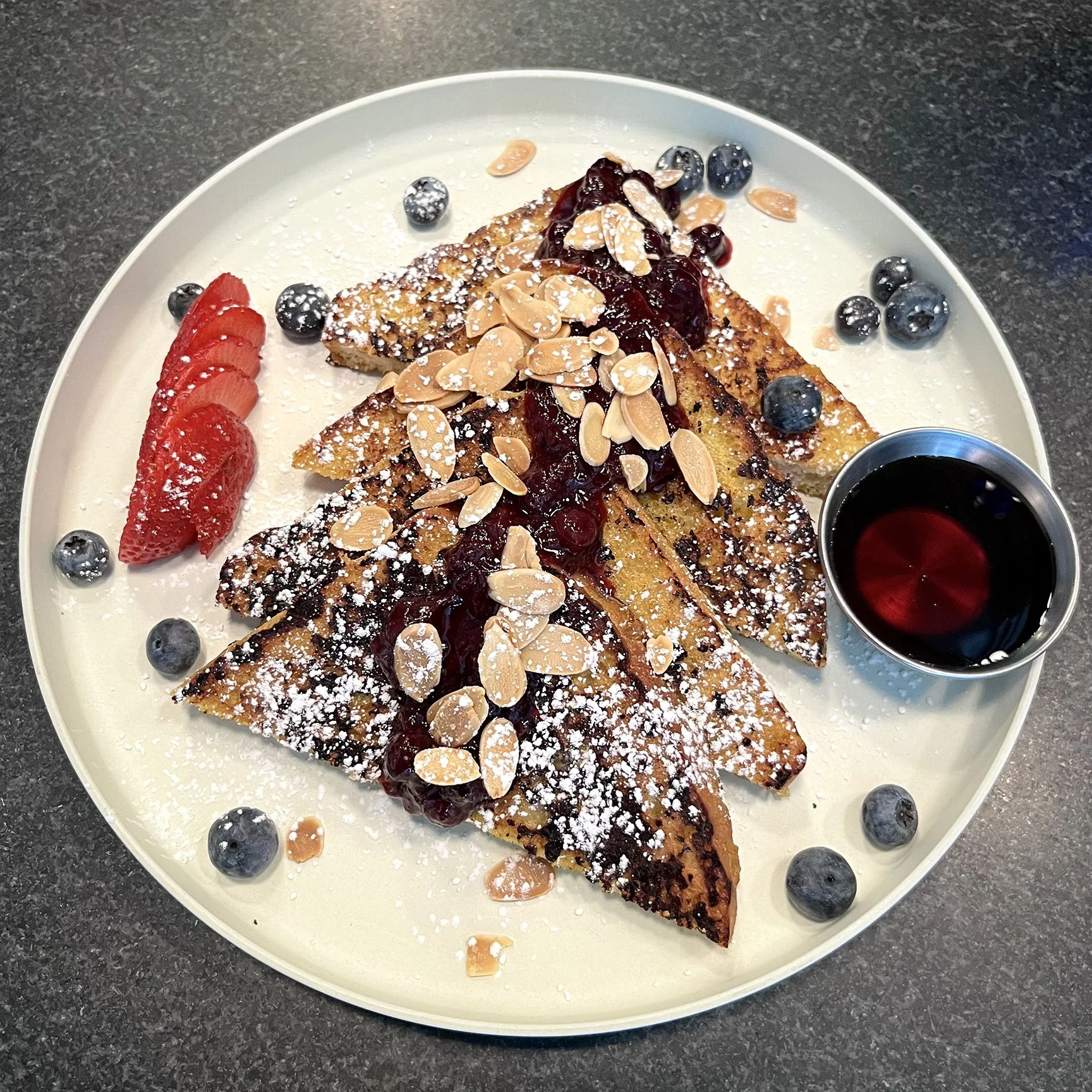 - Golden Child French Toast at Urban Vegan Kitchen with warming spices, fruit compote, toasted almonds, powdered sugar and maple syrup.