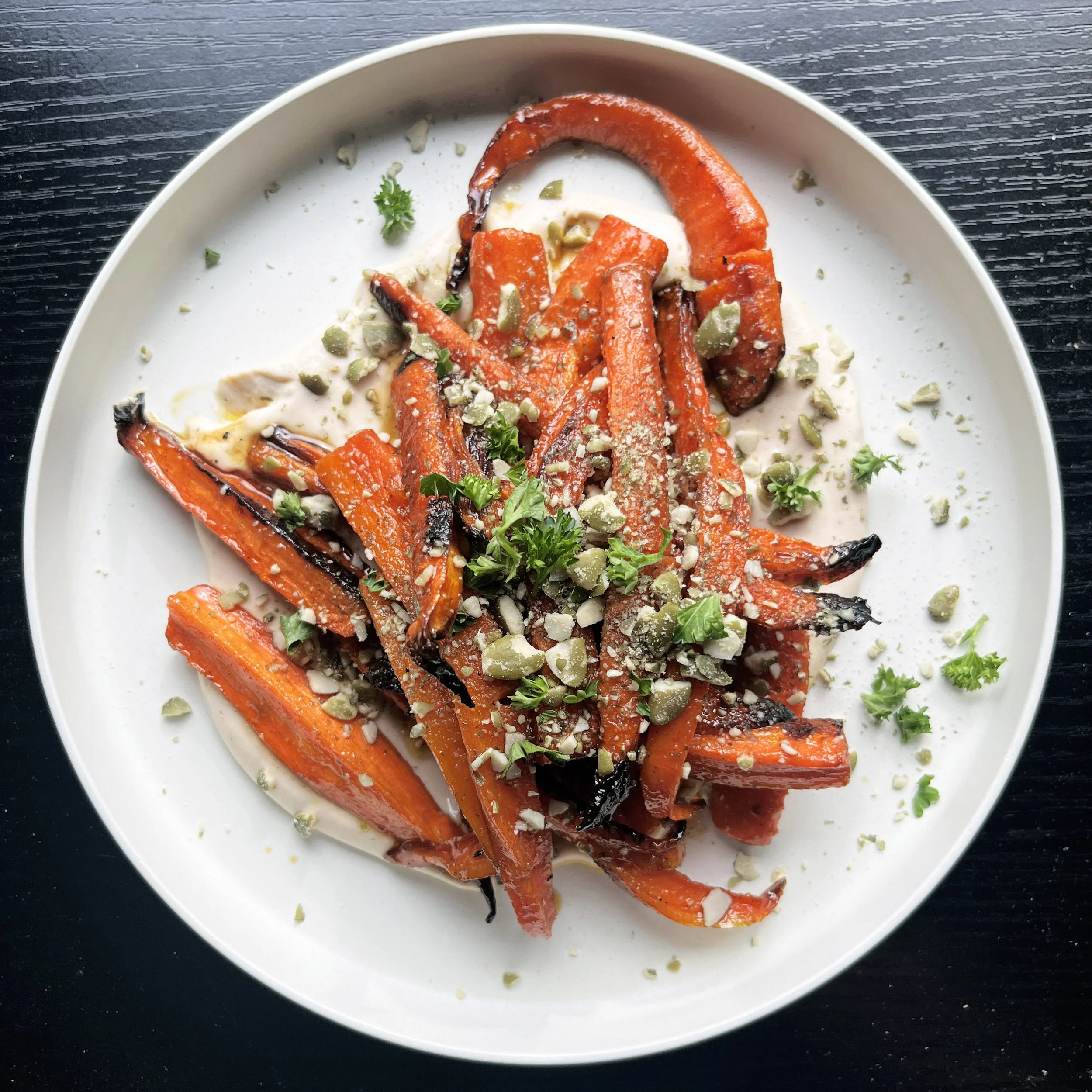 Good Bunny Roasted Carrots with chili agave glaze, whipped tahini, toasted pumpkin seeds, and parsley at Urban Vegan Kitchen in Chelsea, NYC