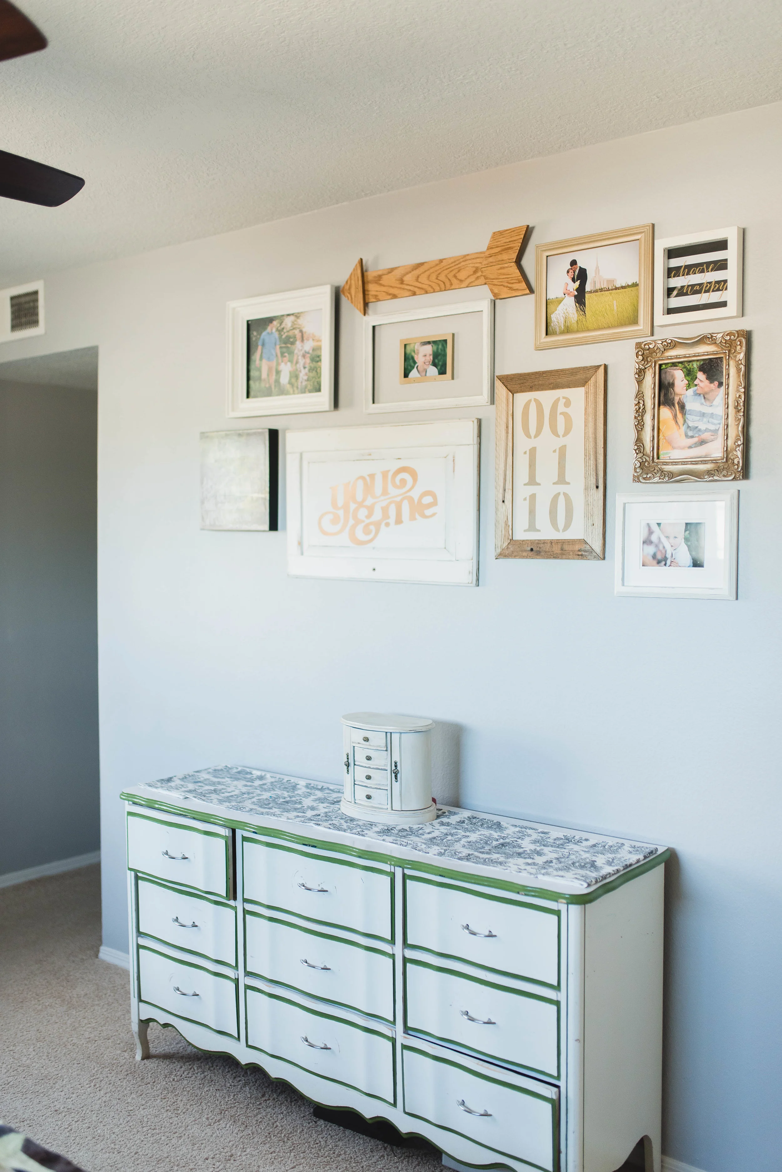 Gallery wall using white, gold, and wood frames