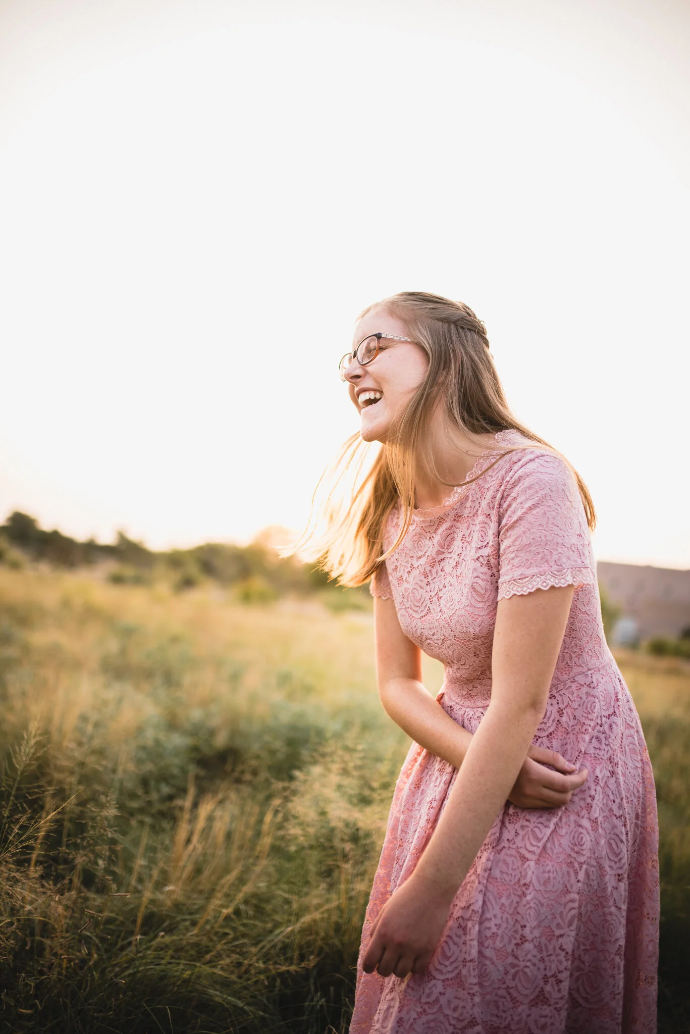 Senior girl laughing in field at Alameda Open Space Albuquerque, NM