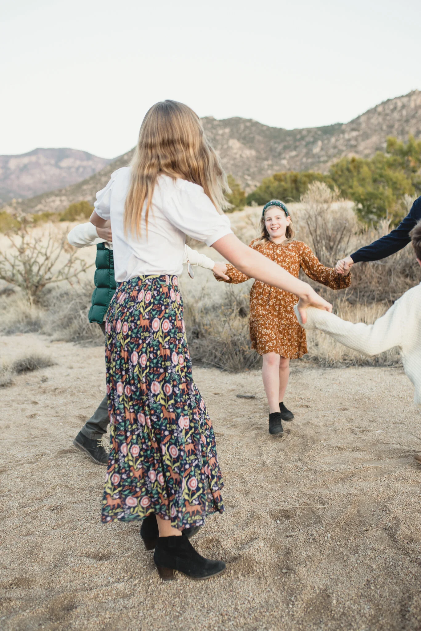 Family holding hands in wash at Elena Gallegos, Albuquerque