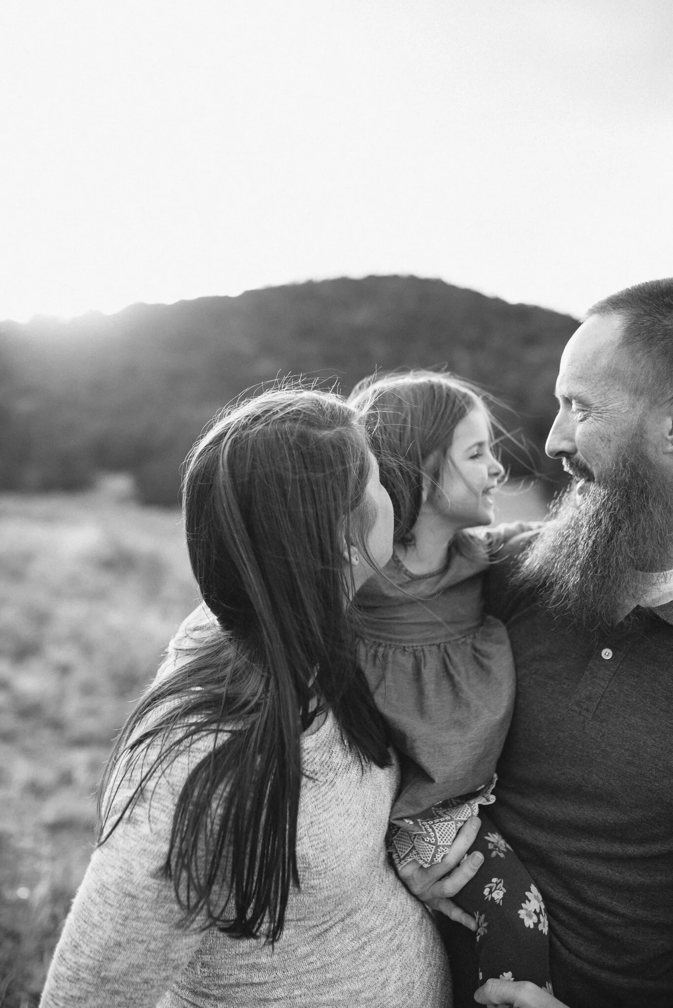 Daughter with arms around parents in Sandia Mountains, Albuquerque
