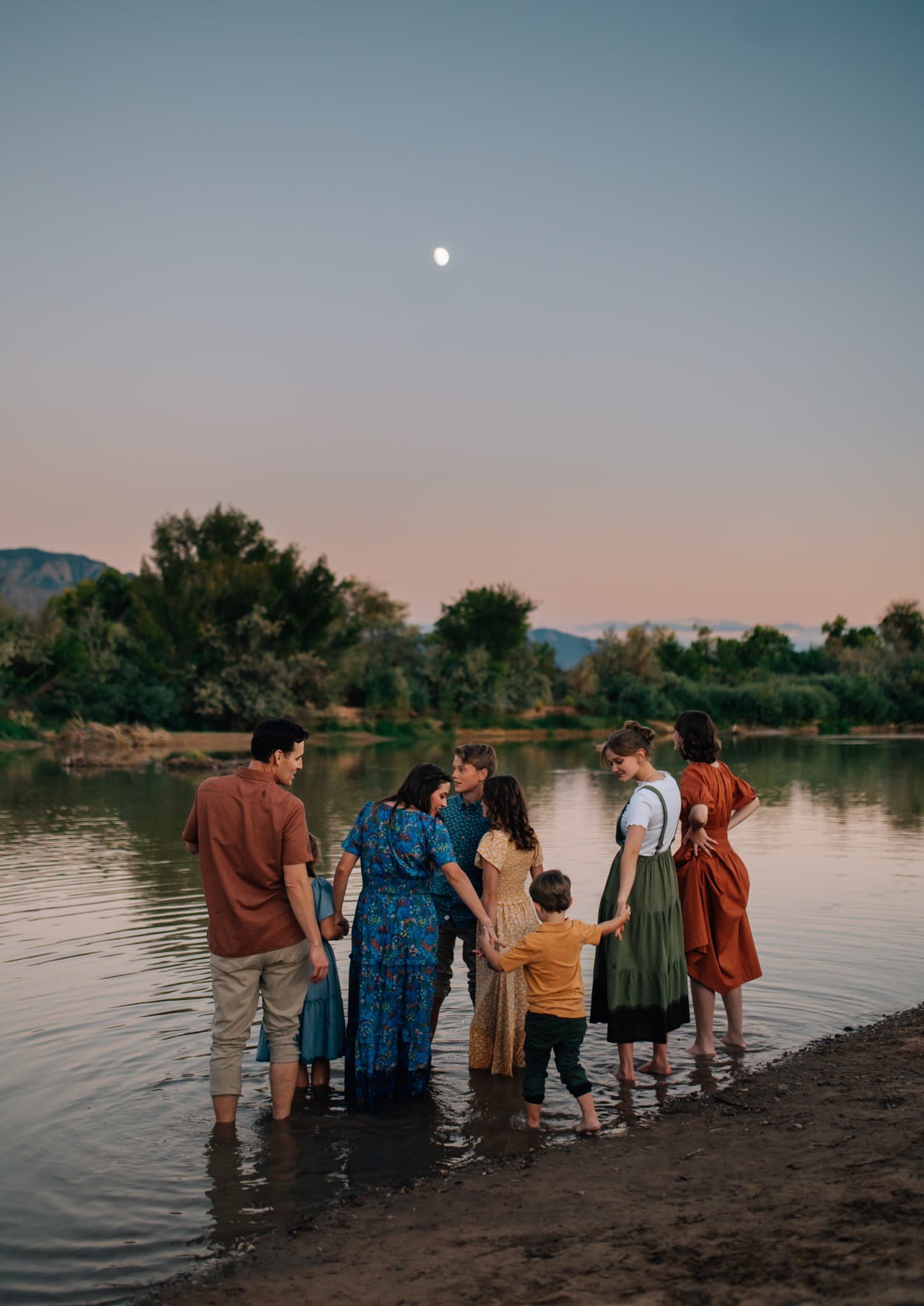 Family with 6 kids wading in river