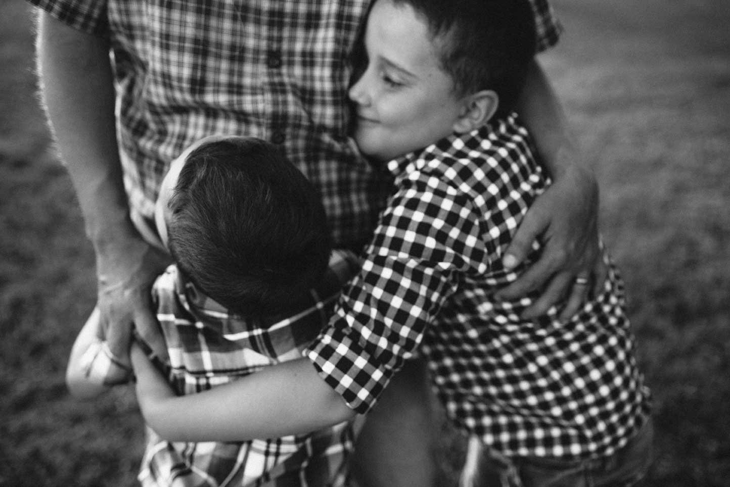 Two boys hugging dad