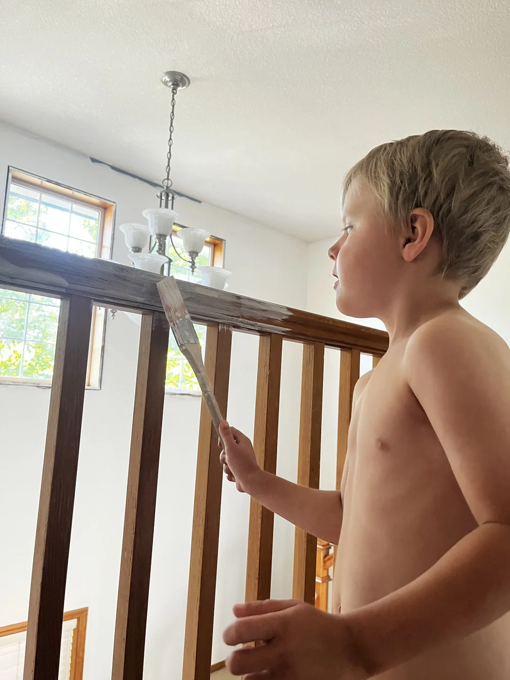 My little helper with painting the staircase railing
