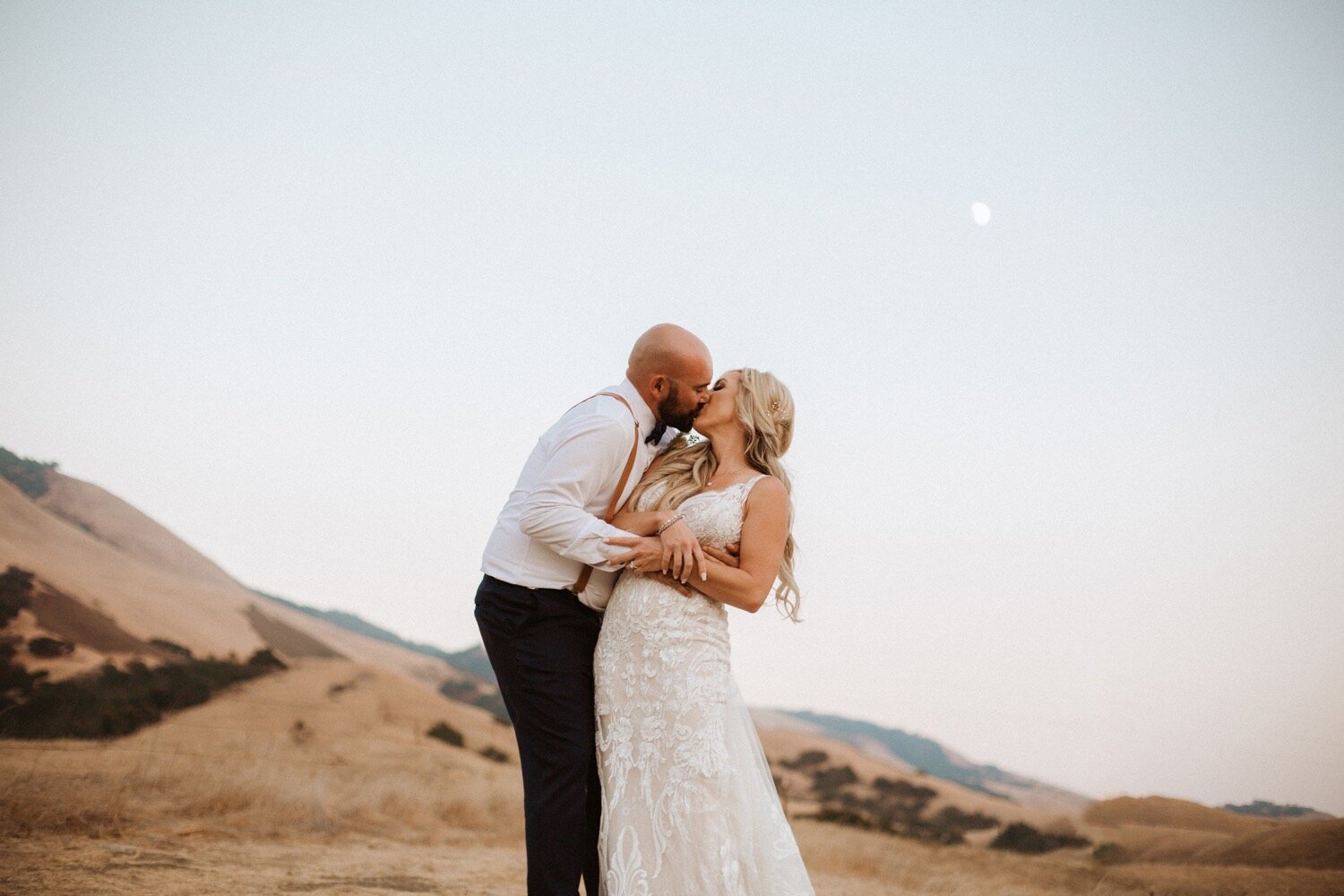 bride and groom kiss during sunset at their higuera ranch wedding. san luis obispo wedding photographer poppy &amp; vine