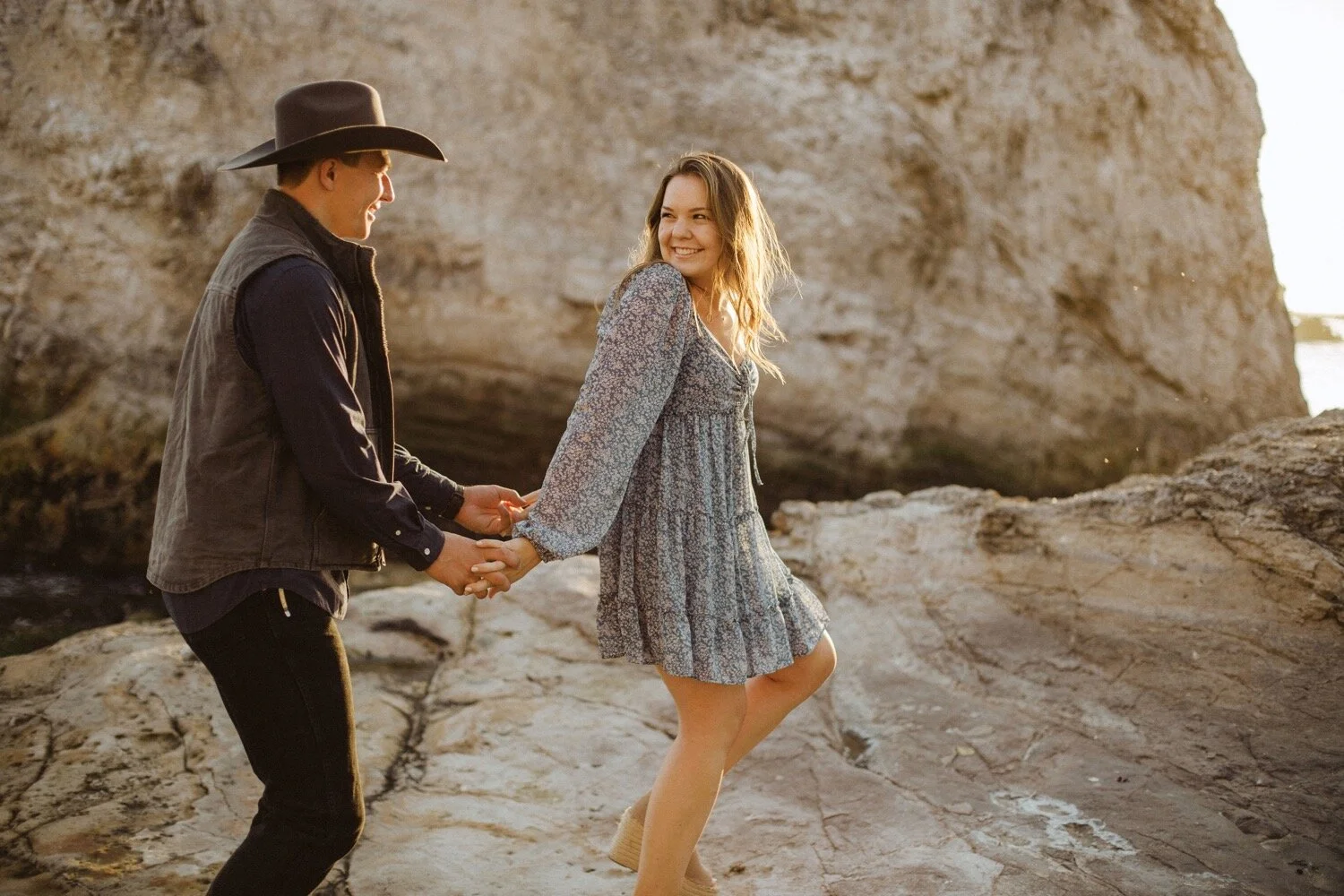couple walks playfully during their pismo beach anniversary session couples photoshoot. wedding photographers san luis obispo poppy and vine