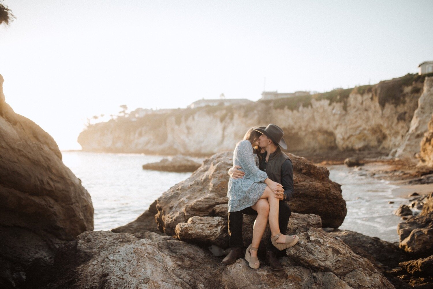  couple kisses each other at golden hour during their pismo beach anniversary session couples photoshoot at dinosaur caves park. wedding photographers slo poppy and vine 