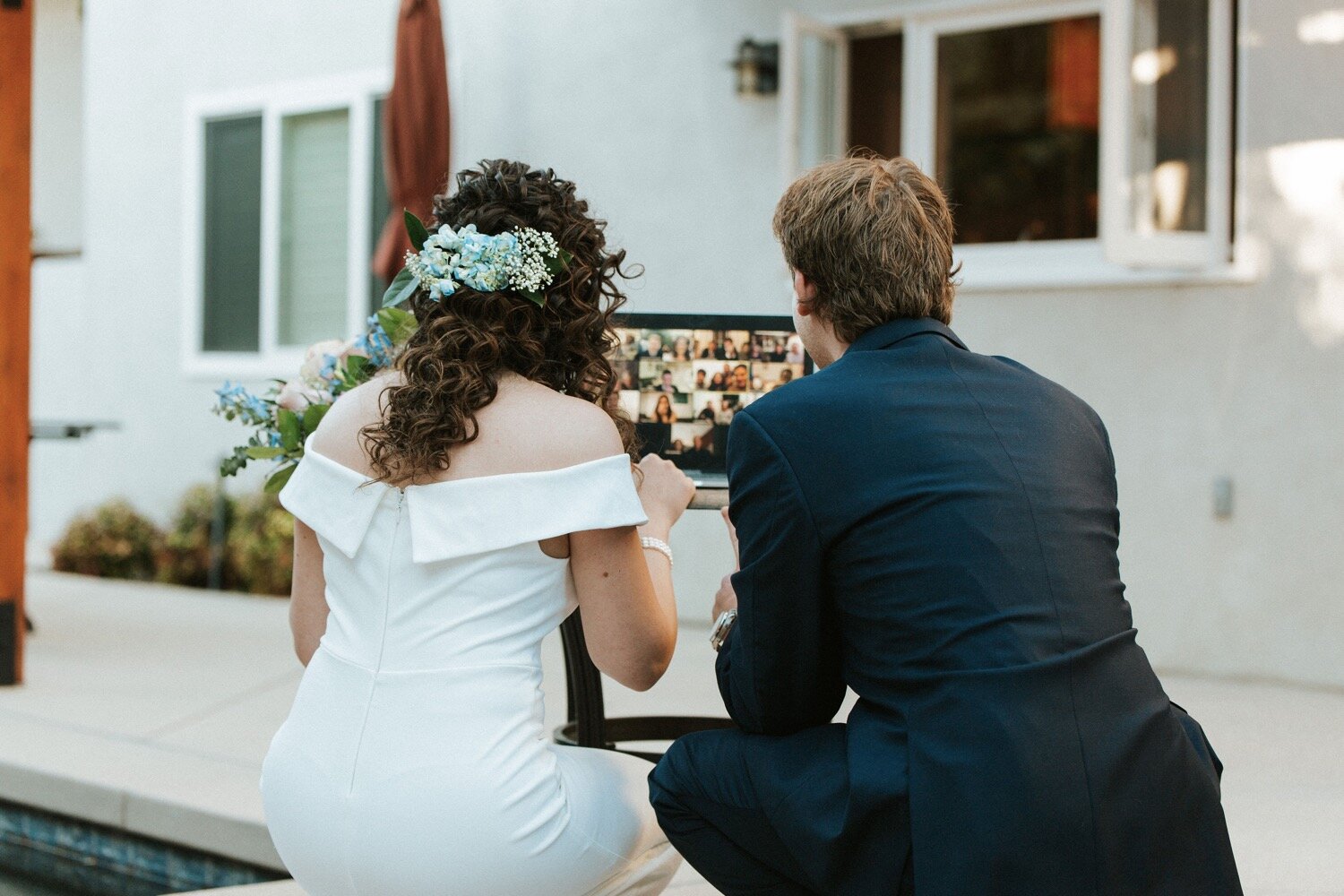  bride and groom greet family and friends who tuned into their wedding ceremony via zoom. the couple could not have their full wedding due to the coronavirus, so they opted for an intimate elopement outside of los angeles, captured by california wedd