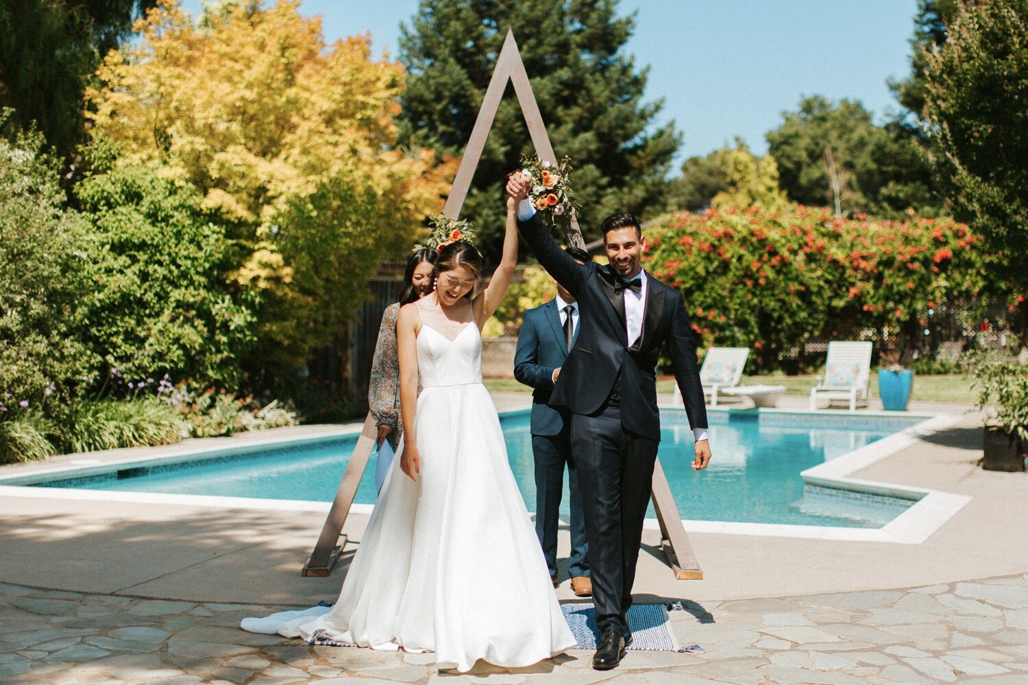  bride and groom cheer excitedly as they are officially pronounced husband and wife at their intimate backyard wedding ceremony in los gatos, california, captured by central coast wedding photographer poppy and vine 