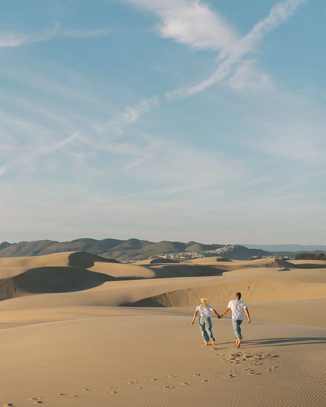 Hi 2026!!!!!!

Our first time at the dunes in actual years, and what an afternoon to make us fall all the way back in love with this blank canvas of a landscape, running around with Alexandra and Nick!

.
.
.
.
.
Movement centered engagement photos a