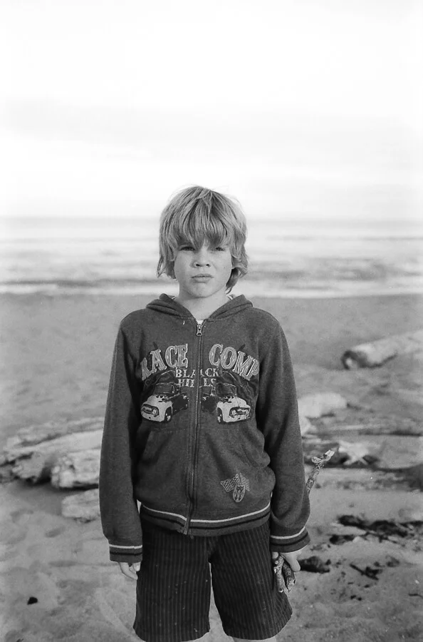seeing a way back - boy collecting sticks on the beach.jpg