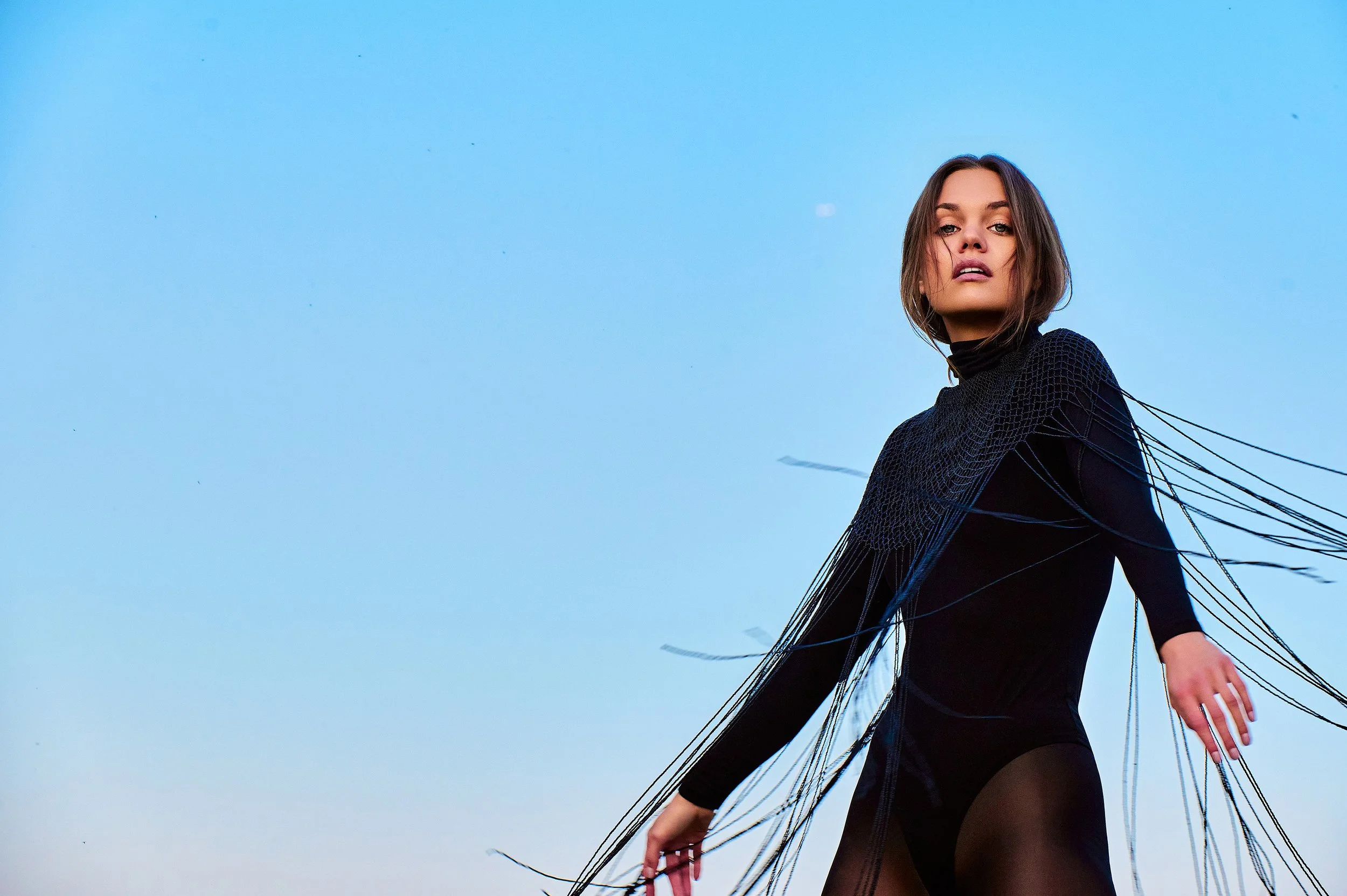 fashion high end campaign editorial photographer on location Vernon boardwalk blue sky movement