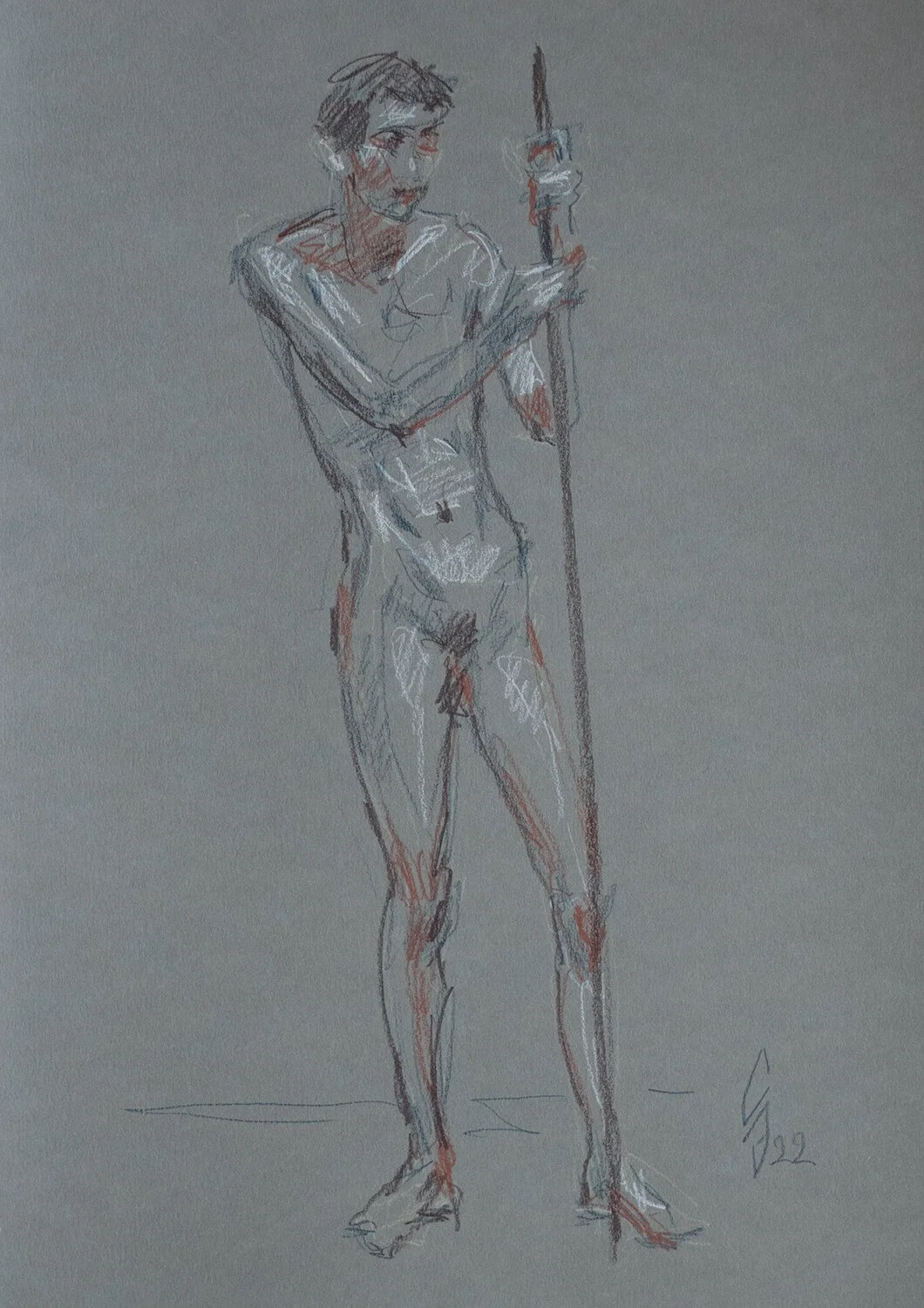 Naked young man leaning on a stick