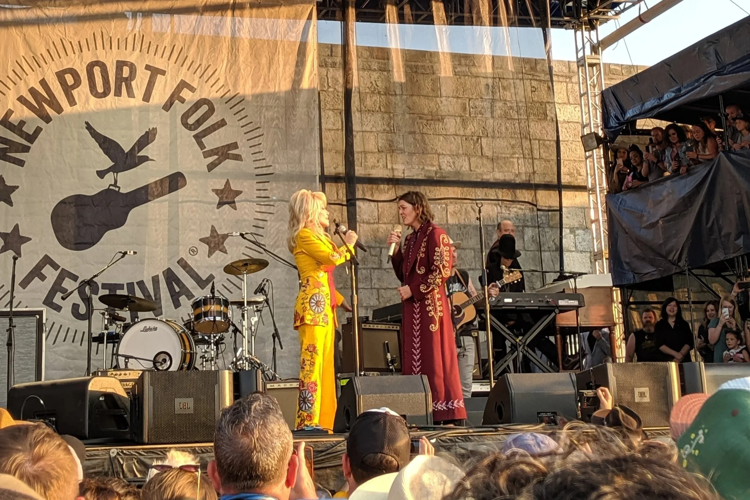 Dolly Parton and Brandi Carlile singing on stage at Newport Folk 2019