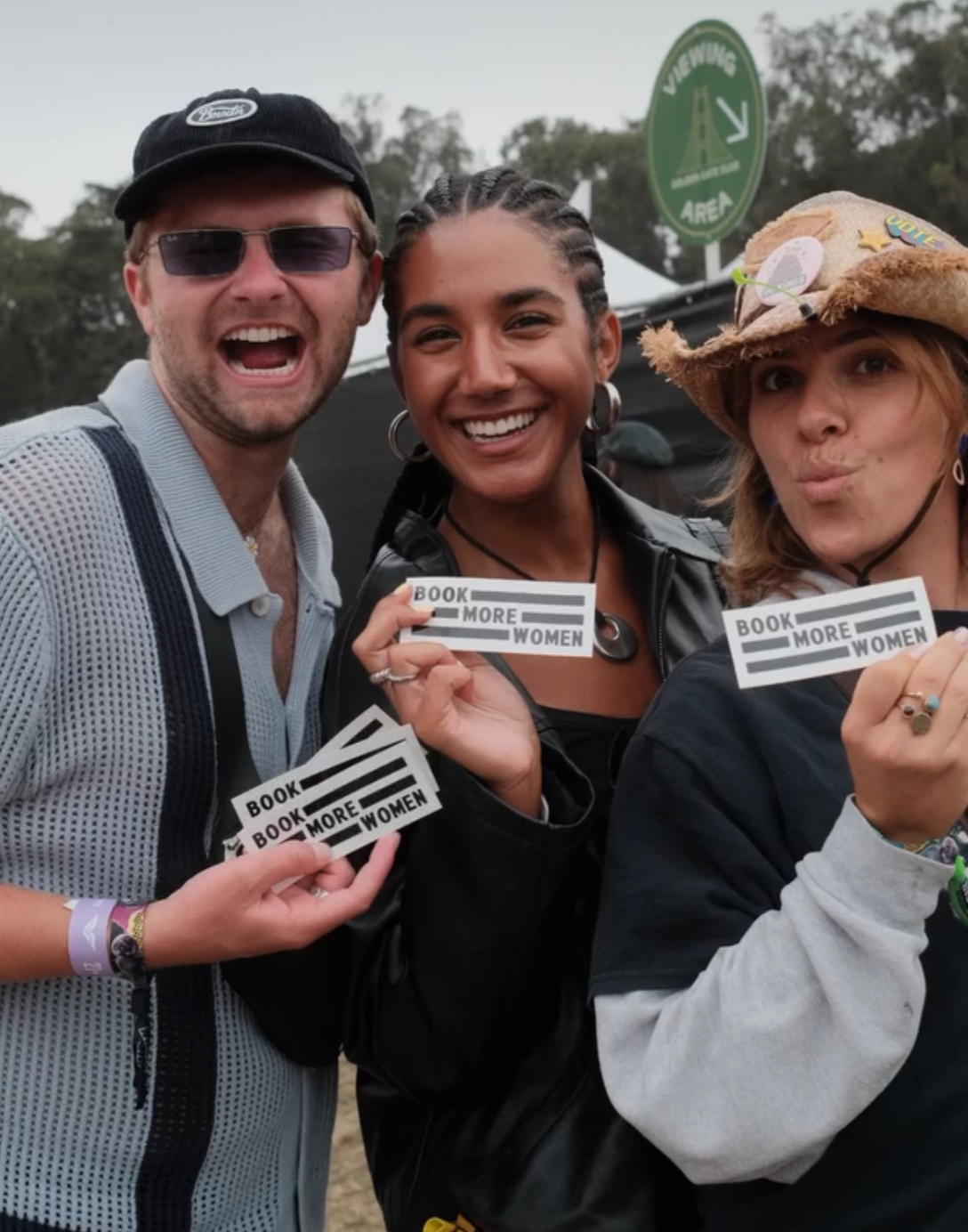 Friends with the Book More Women stickers at a music festival