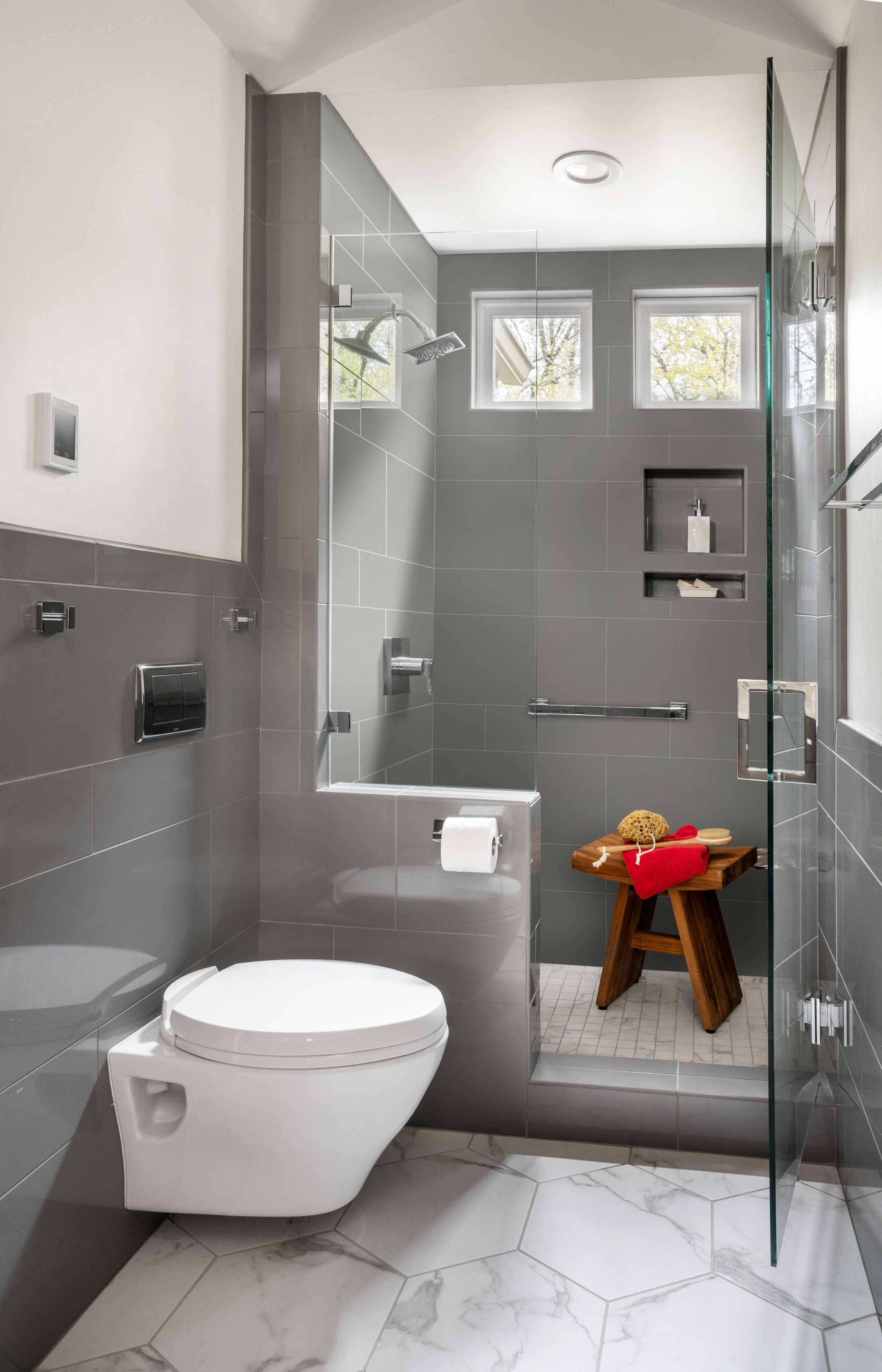 The wall mounted toilet creates extra space to access the shower. 