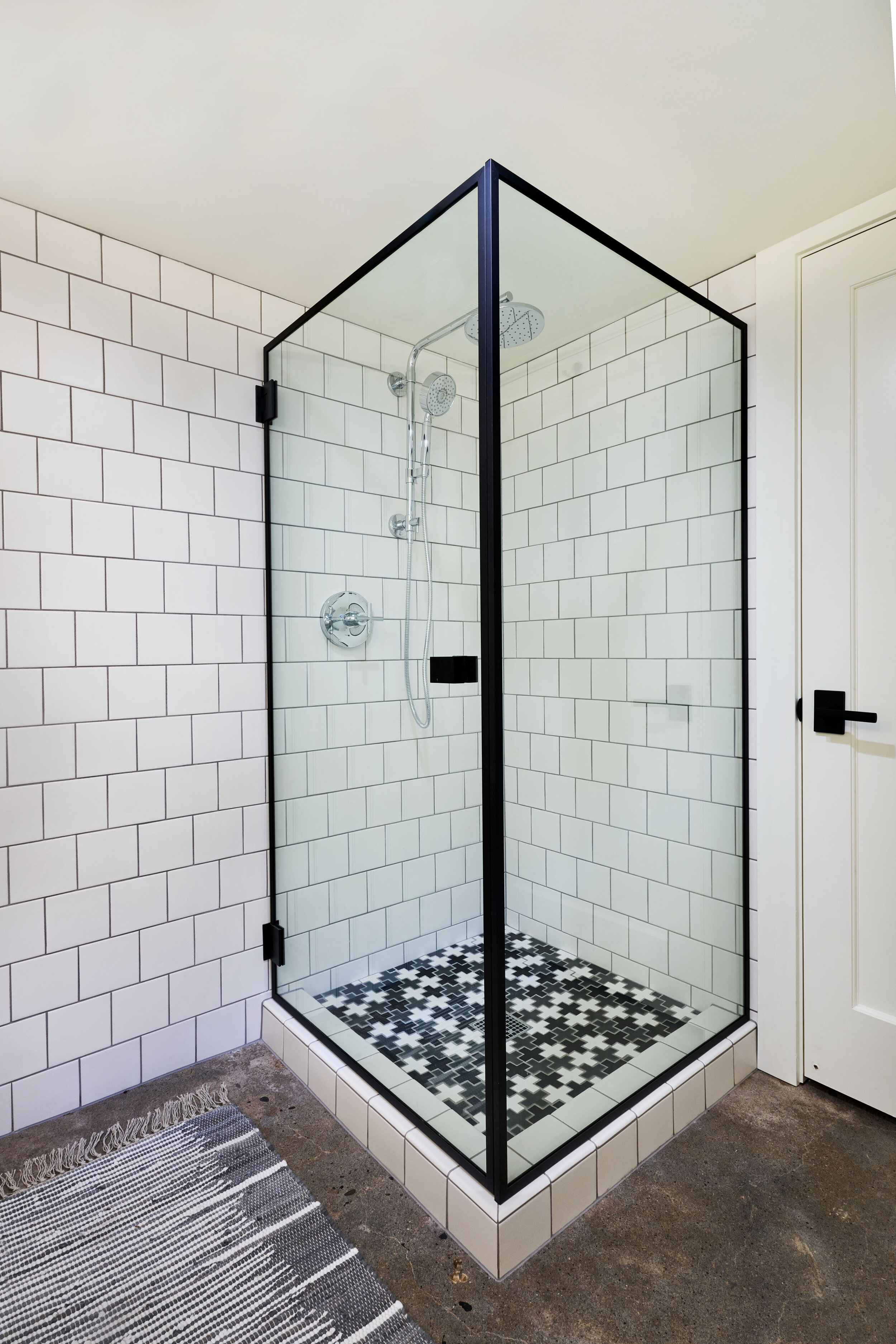 Shower with exposed pipe, Pratt Larson tile and Kohler fixtures.