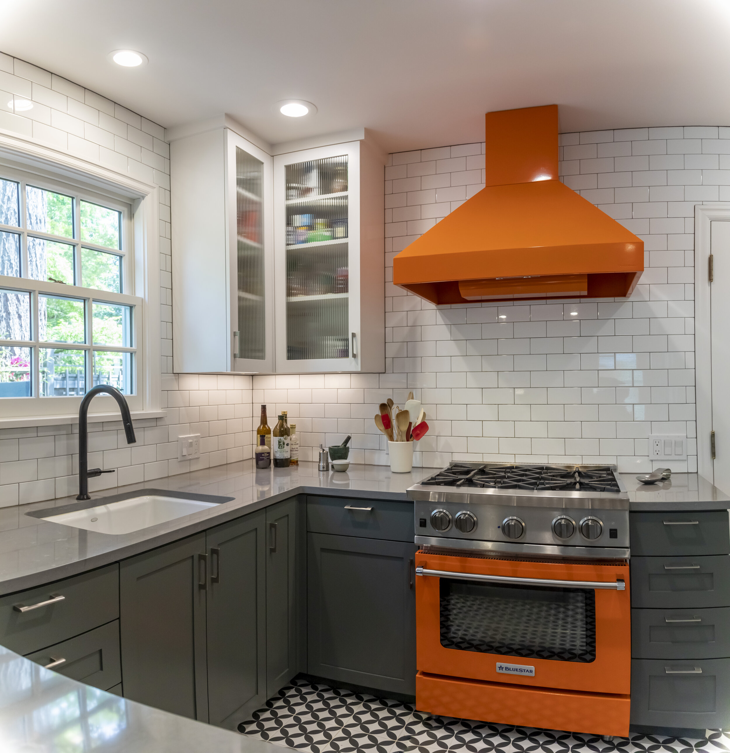 Orange range and hood serve as the room's focal point.