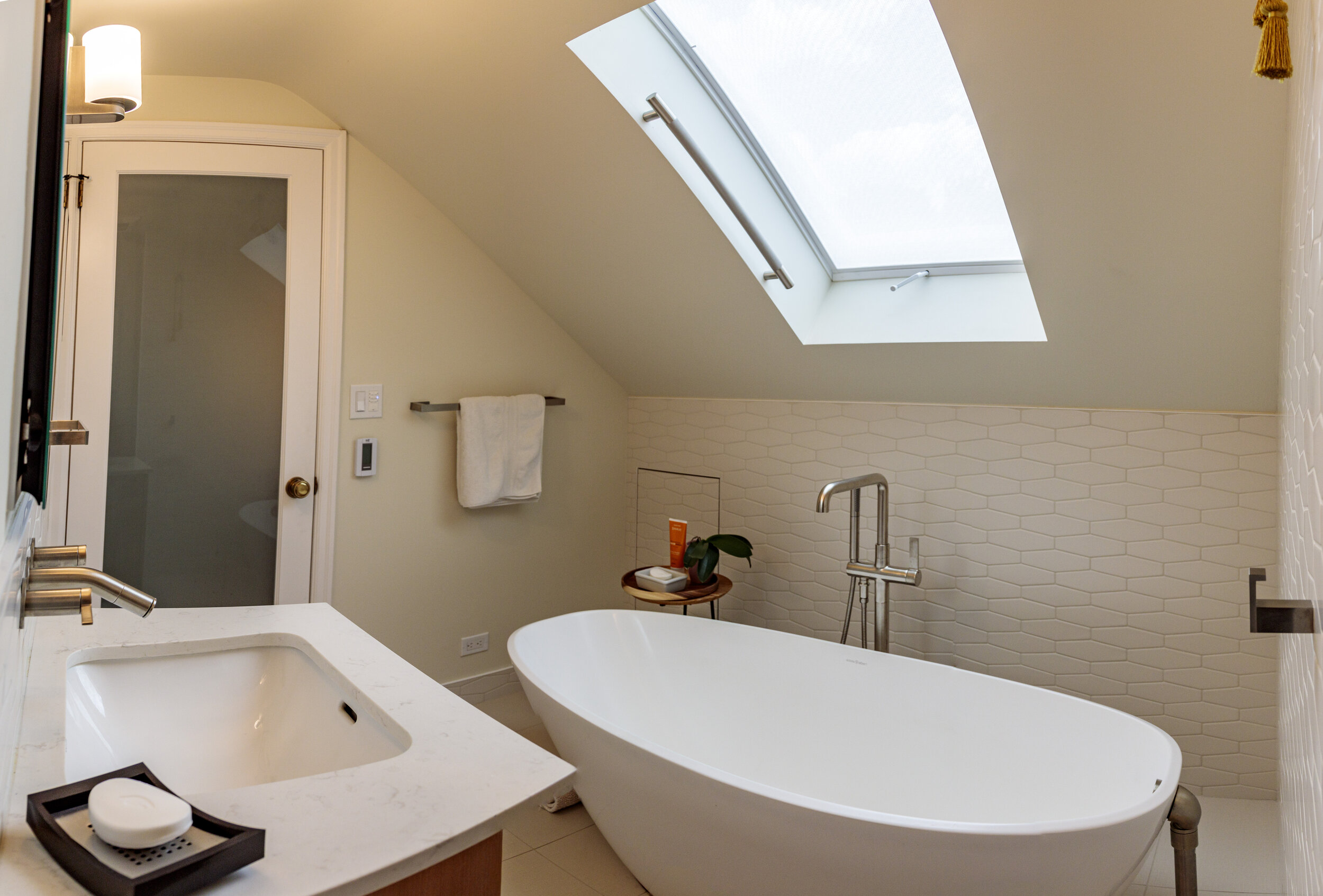 Sculptural soaking tub in the upstairs bath.