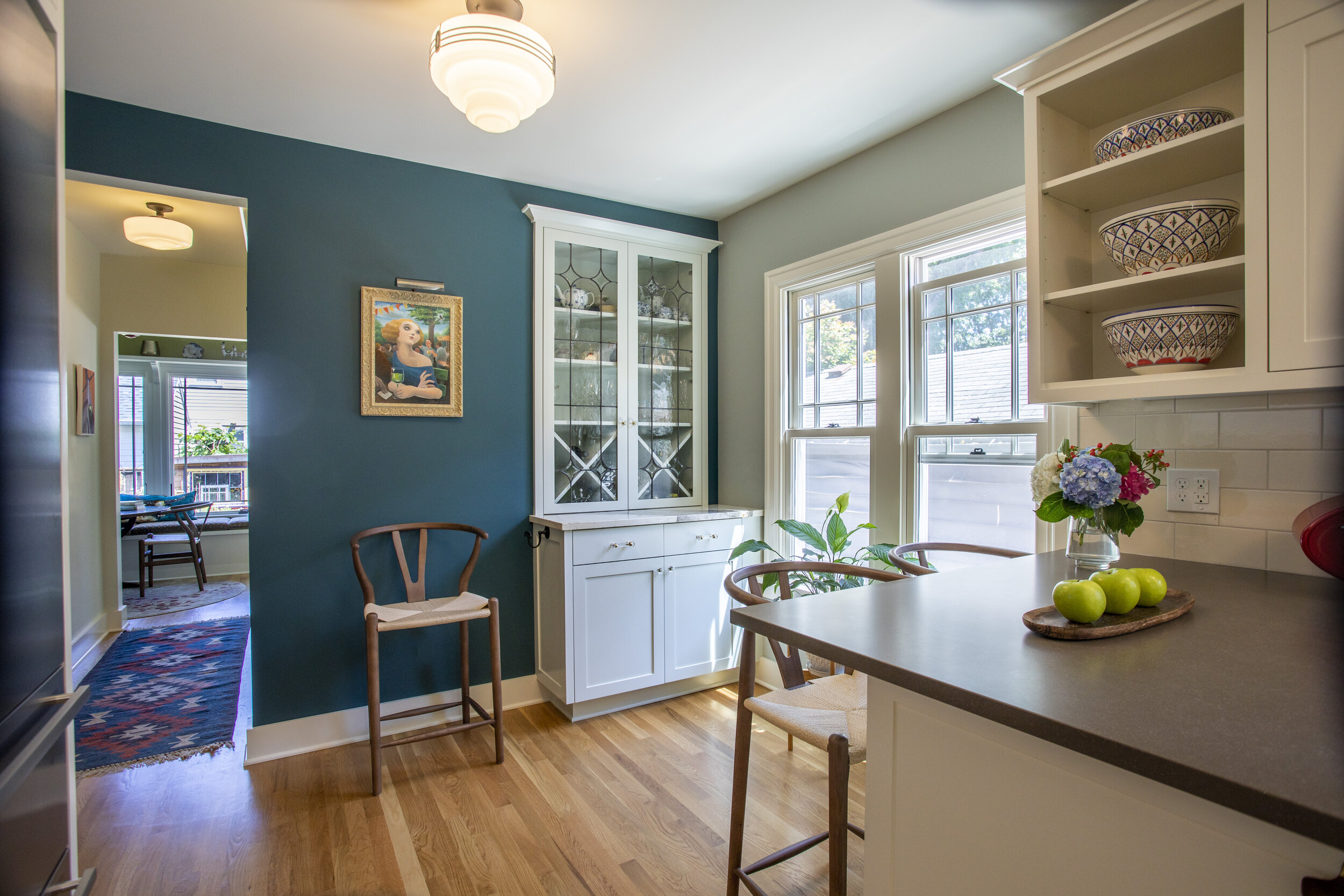 Expanded living space was created by moving the former nook to the space above the stairs to basement.