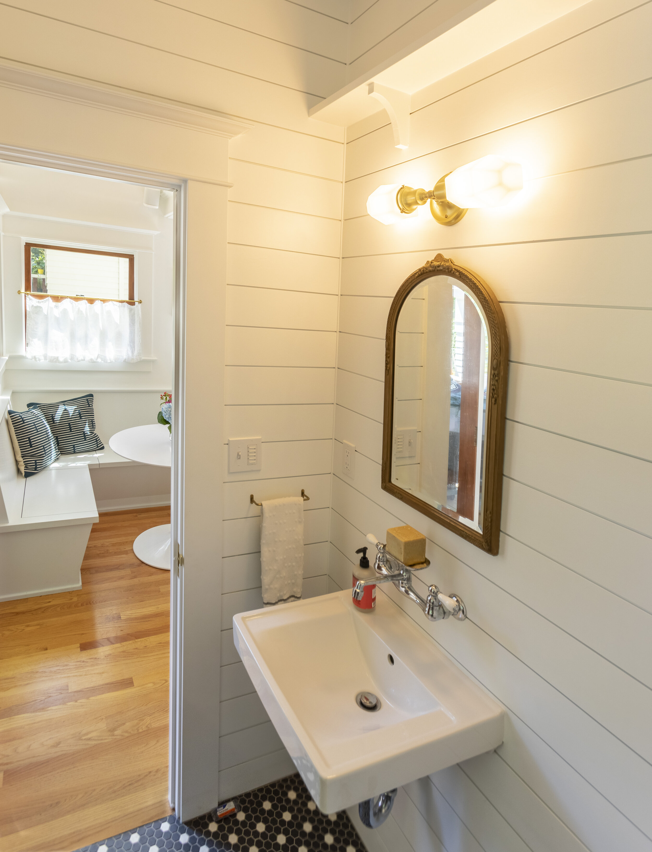 Shiplap in powder room pays homage to old porch.