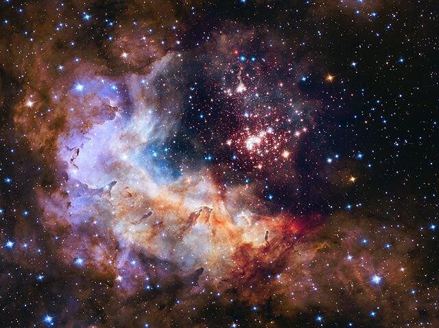 'The brilliant tapestry of young stars flaring to life resembles a glittering fireworks display in this Hubble Space Telescope image. The sparkling centerpiece of this fireworks show is a giant cluster of thousands of stars called Westerlund 2. The c