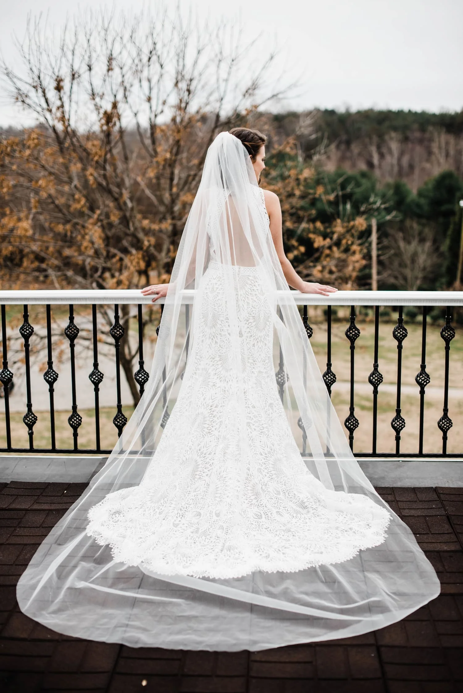 bride with veil outside on balcony.jpg