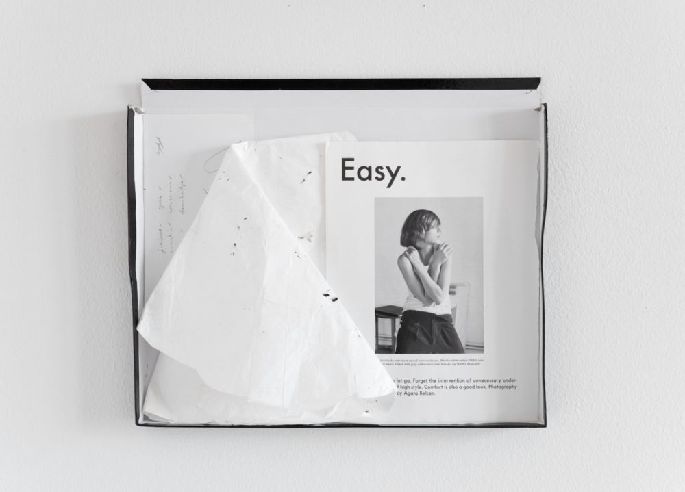 relaxing chamber , 2015 cardboard box lid, magazine page, tyvek, pva, feathers dust, found list of crossword answers