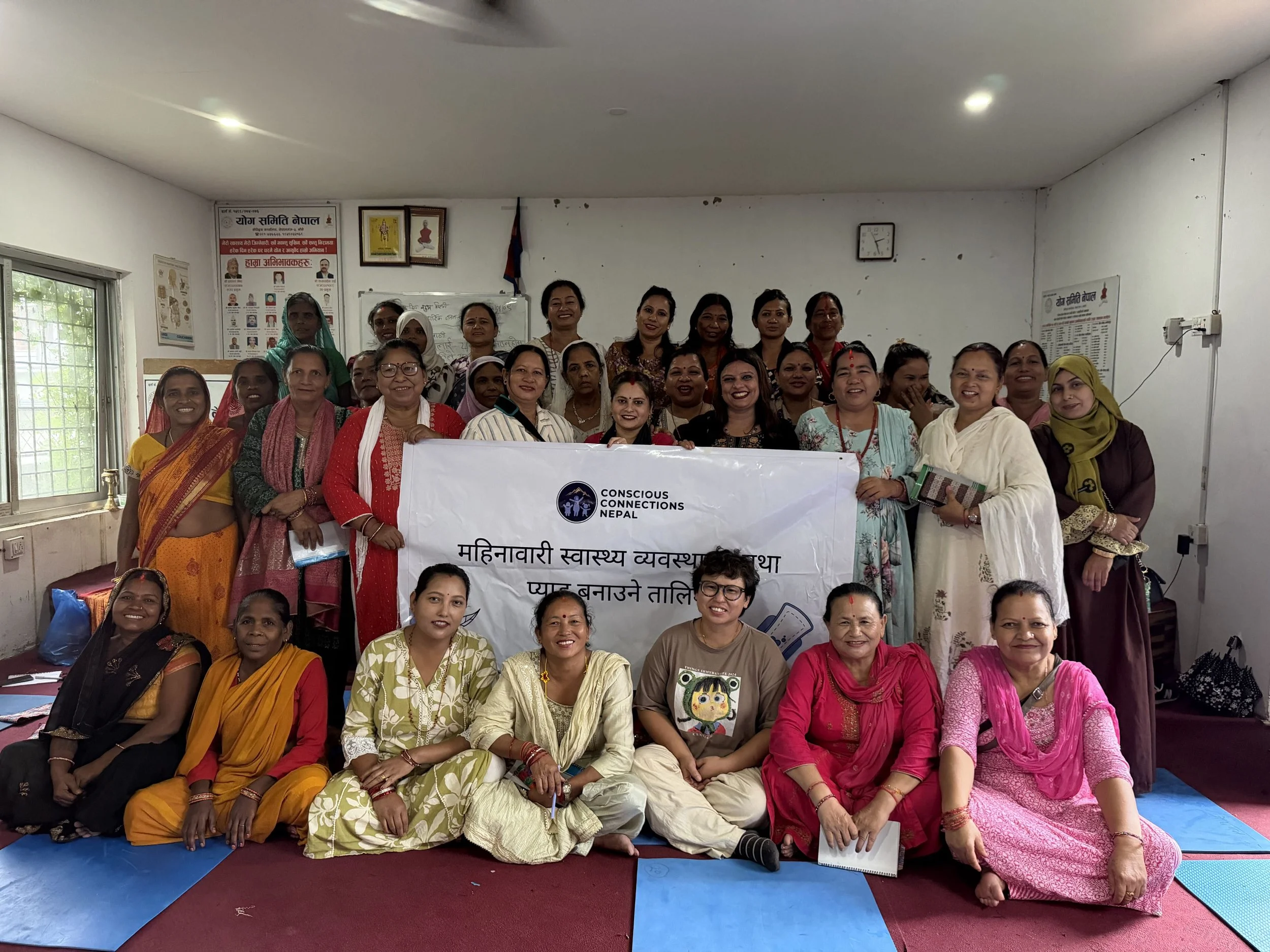Photo of all the training participants with a training sign.