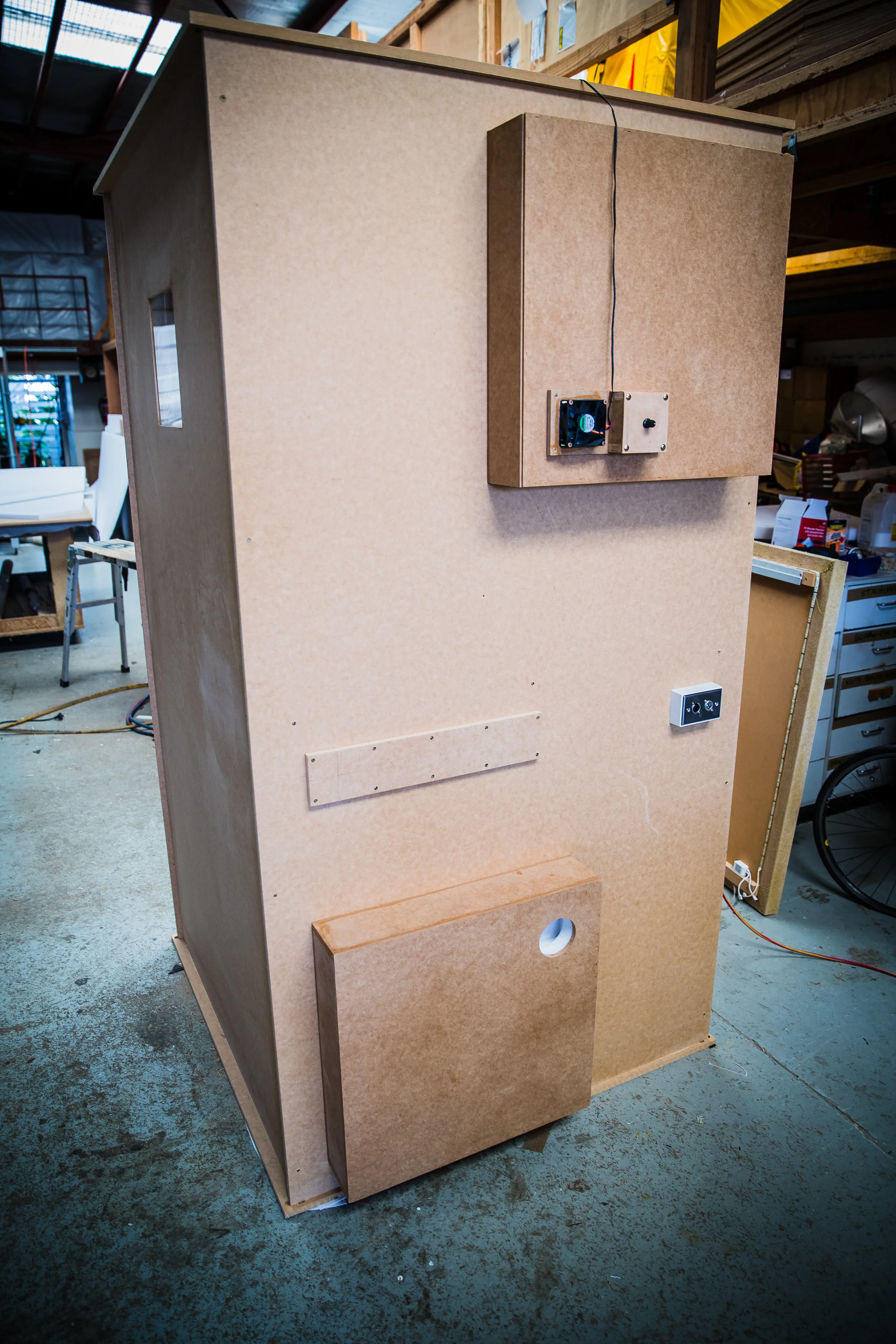 Rear of vocal booth with ventilation boxes and patch bay