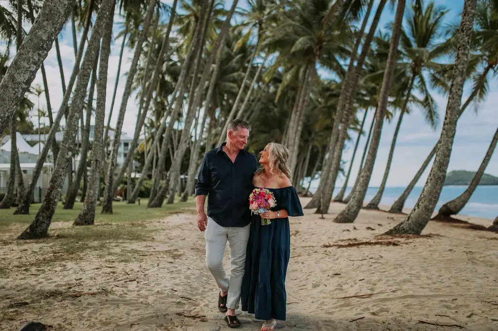 Couple eloping on Palm Cove beach amongst the palms in Cairns with I Do Drive Thru — elopement celebrant and packages from $400