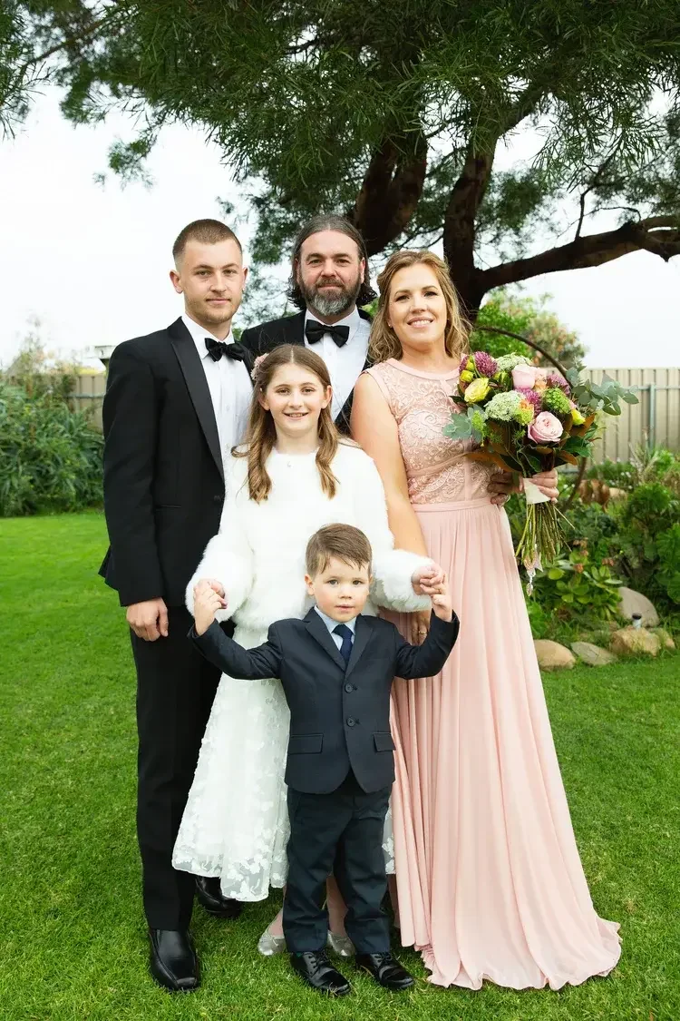 Couple marrying with their children in their backyard in Adelaide with I Do Drive Thru — family elopement from $400